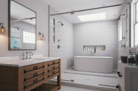 Modern bathroom with a freestanding bathtub, glass shower enclosure, wooden vanity with double sinks, large mirror, and white subway tile walls.