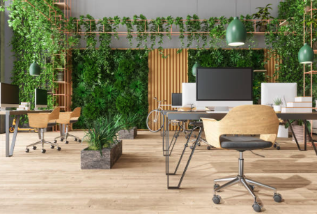Modern office space with green plants, wooden furniture, and several computer desks Roofing and painting in Bucks County