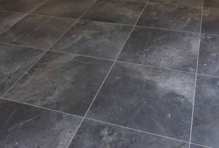 Close-up of a tiled floor with dark gray tiles Roofing and painting in Bucks County