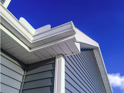 Close-up of house siding and roof against a clear blue sky