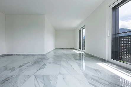Empty modern room with marble flooring and large windows Roofing and painting in Bucks County