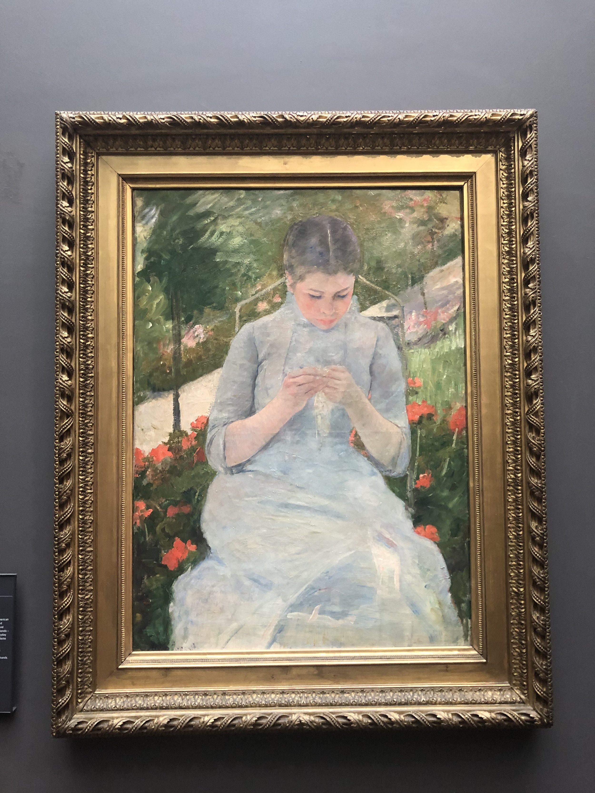 Young Woman Sewing in the Garden by Mary Cassatt
