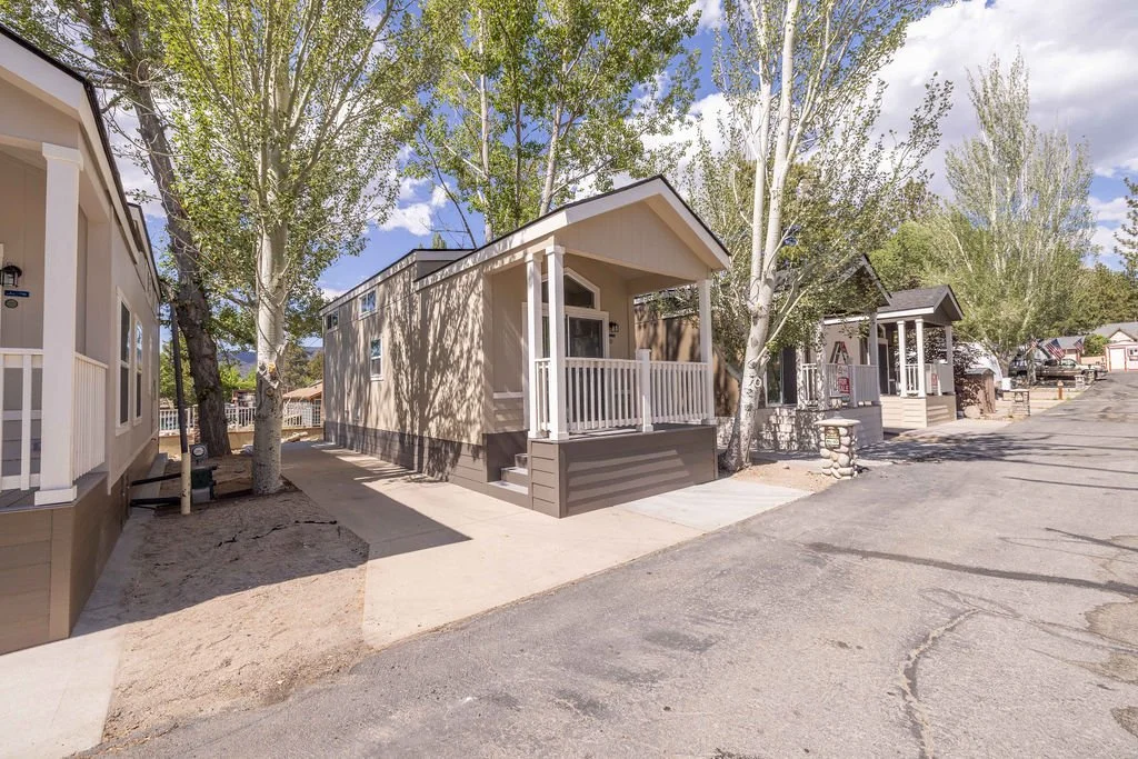 Row of brand new tiny homes and manufactured homes for sale along paved streets at Big Bear Mobile Estates.