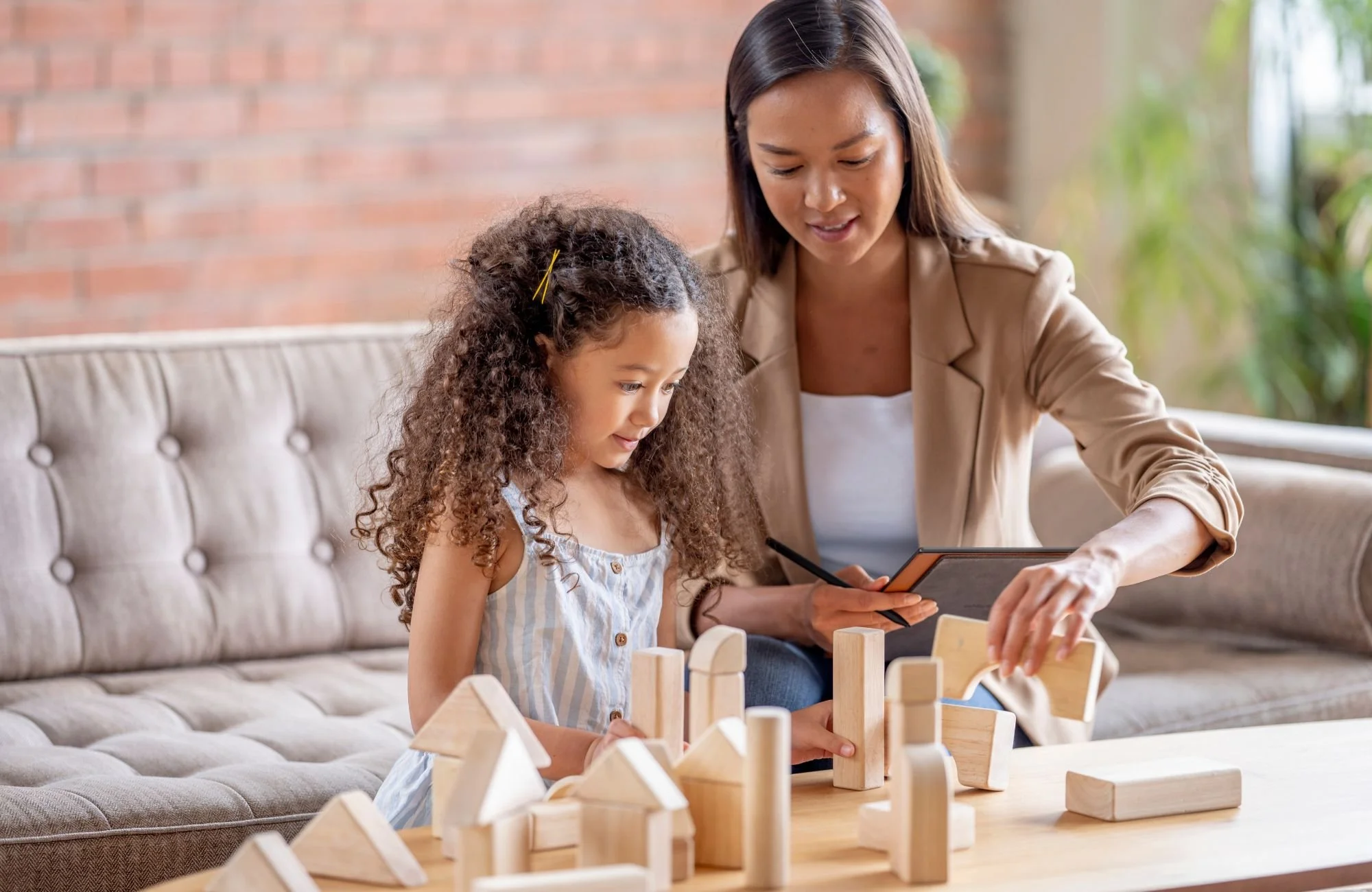 Child playing with wooden blocks during autism evaluation session