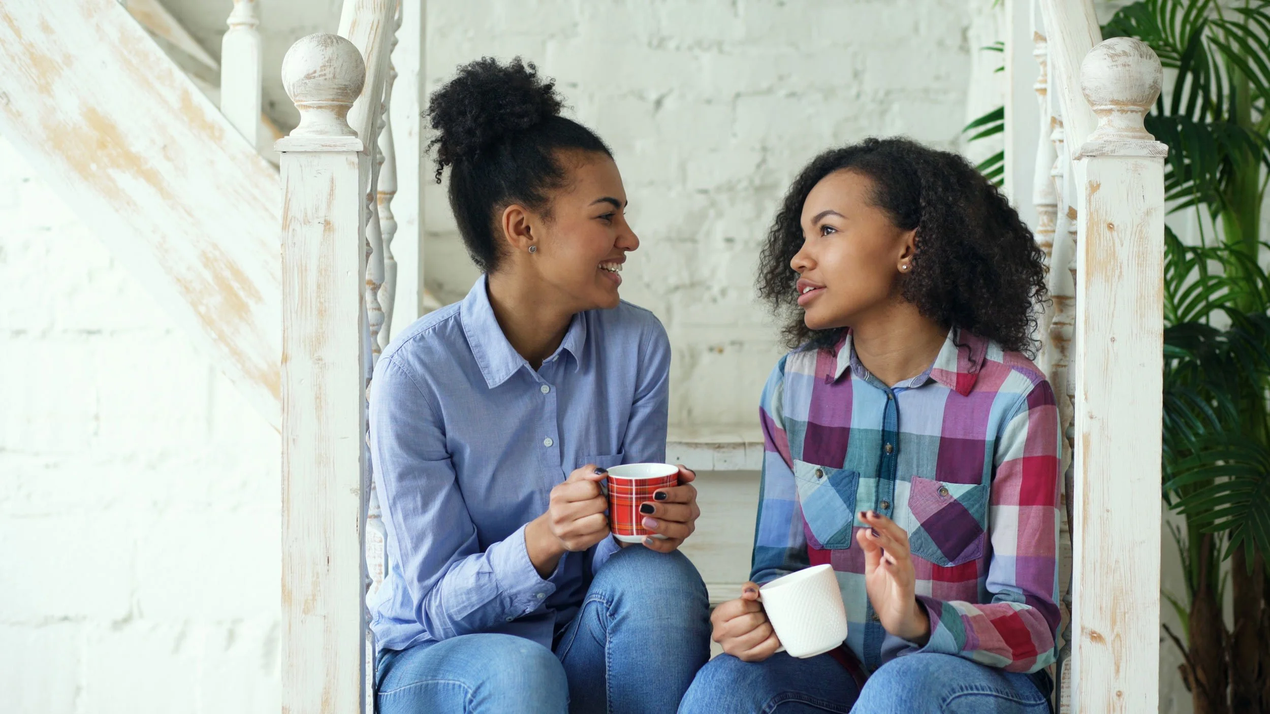 Two teenage girls talking during a PEERS social skills group for teens