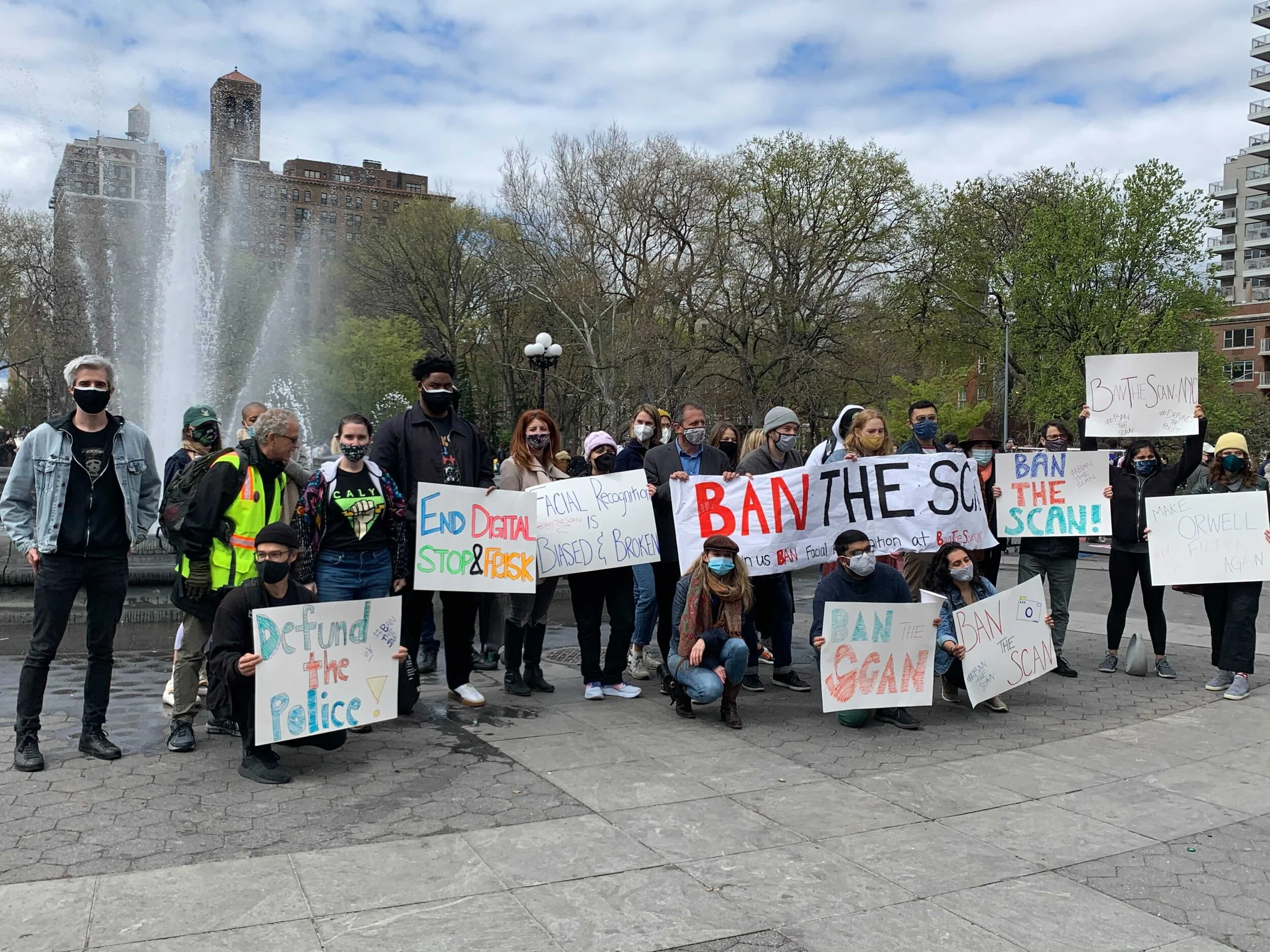 Individuals at a STOP rally in NYC's Washington Square Park