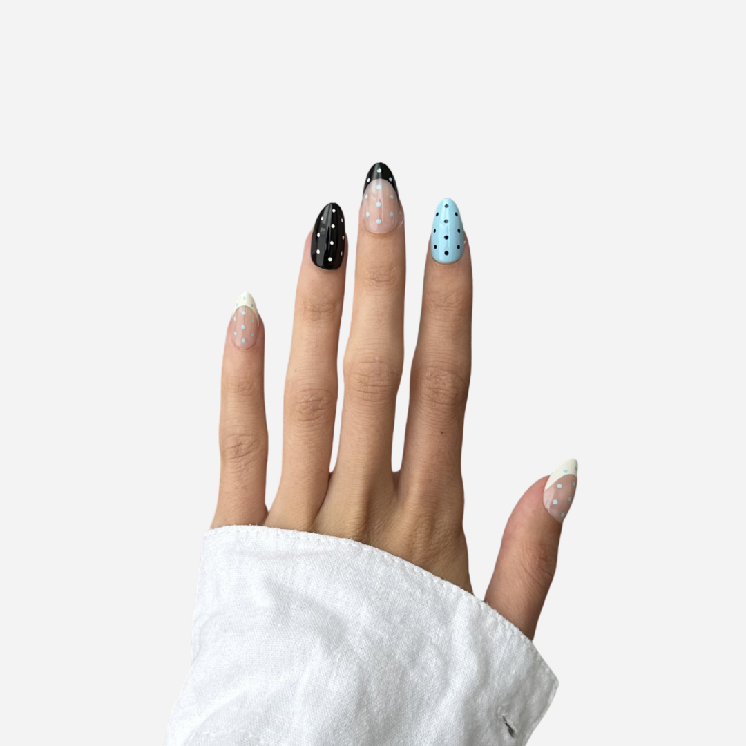 Hand with long, decorated pink and green Strawberry Matcha nails featuring floral and abstract designs.