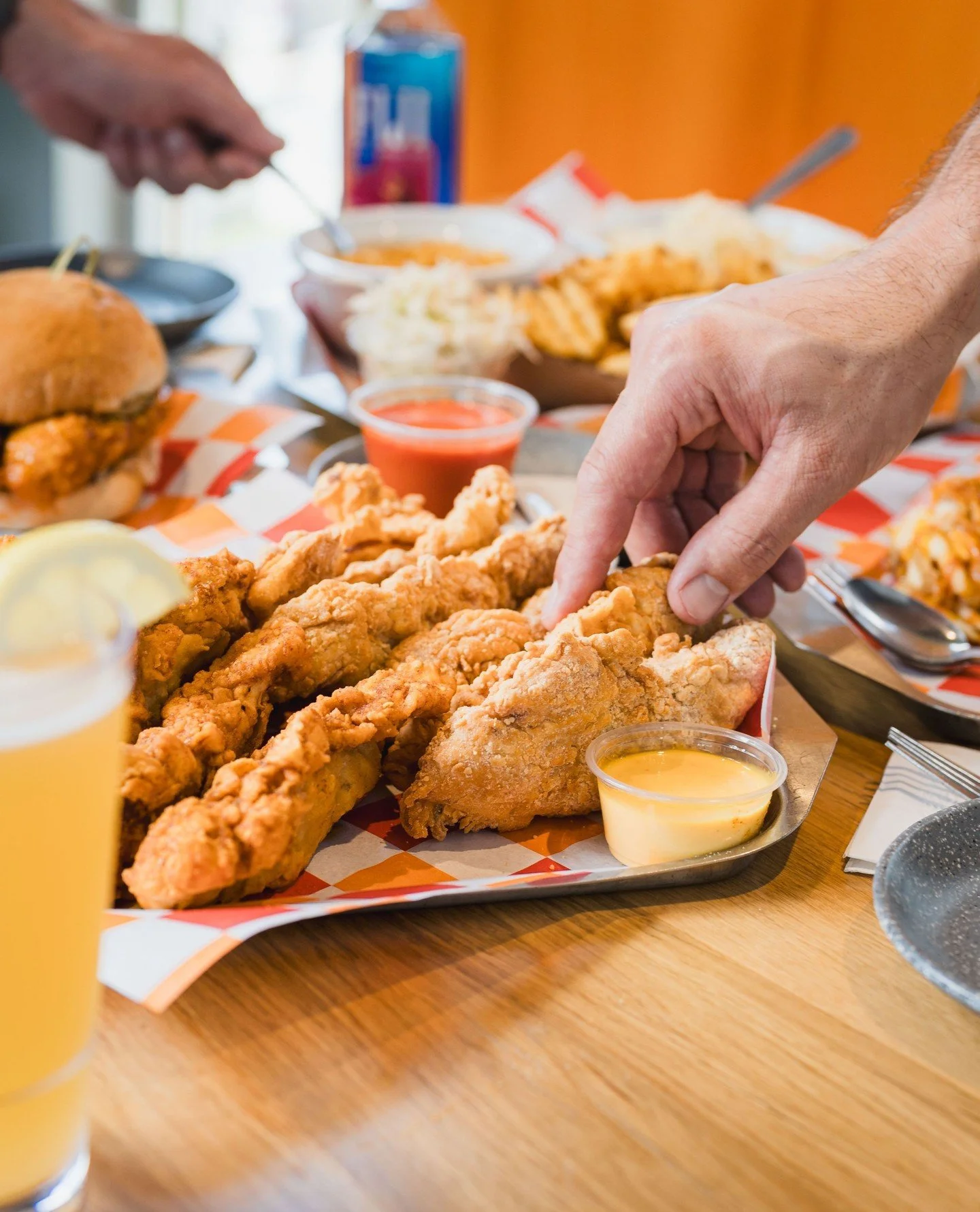 Weekends taste better when the table&rsquo;s full&mdash;friends crammed shoulder to shoulder, cold drinks sweating, chicken sandwiches disappearing faster than we can stack them. If this really is one of the last warm ones, you know what to do.