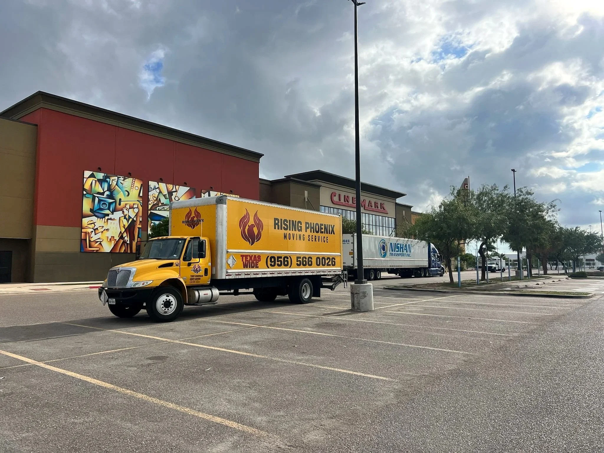 Rising Phoenix Moving Service truck in front of Cinemark Movie Theatre after a move at that location.