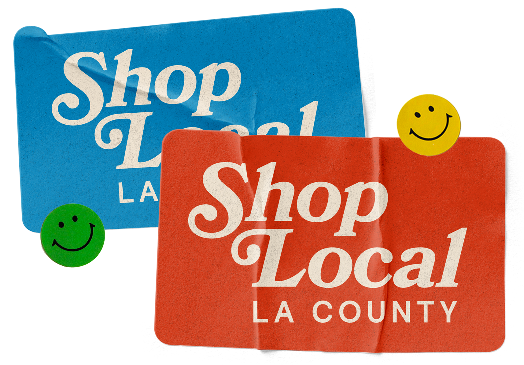 Blue and red bumper stickers with white text reading "Shop Local LA County" and two smiley face stickers, one green and one yellow.