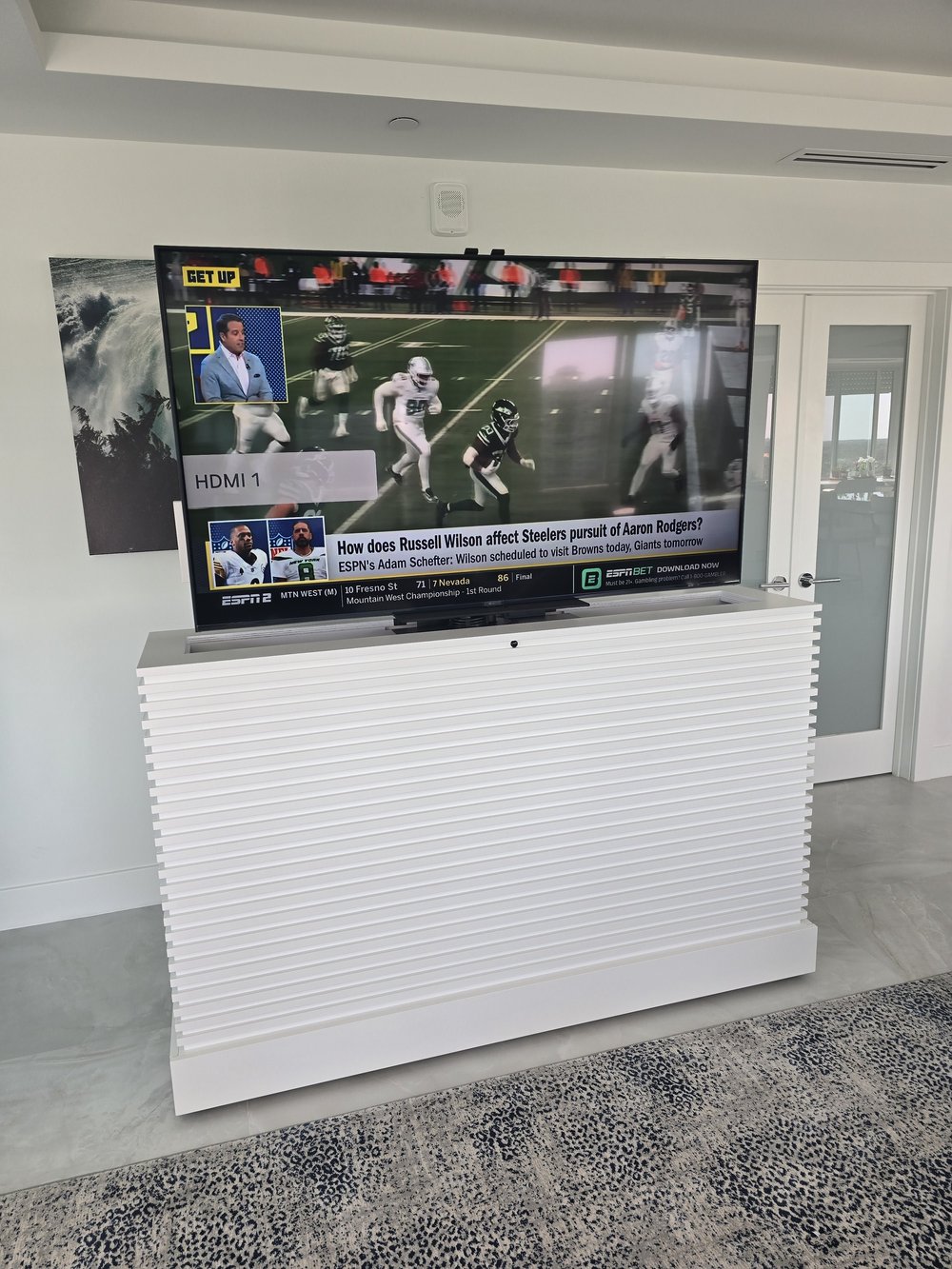 Custom lift cabinet TV installation with hidden wiring and motorized lift