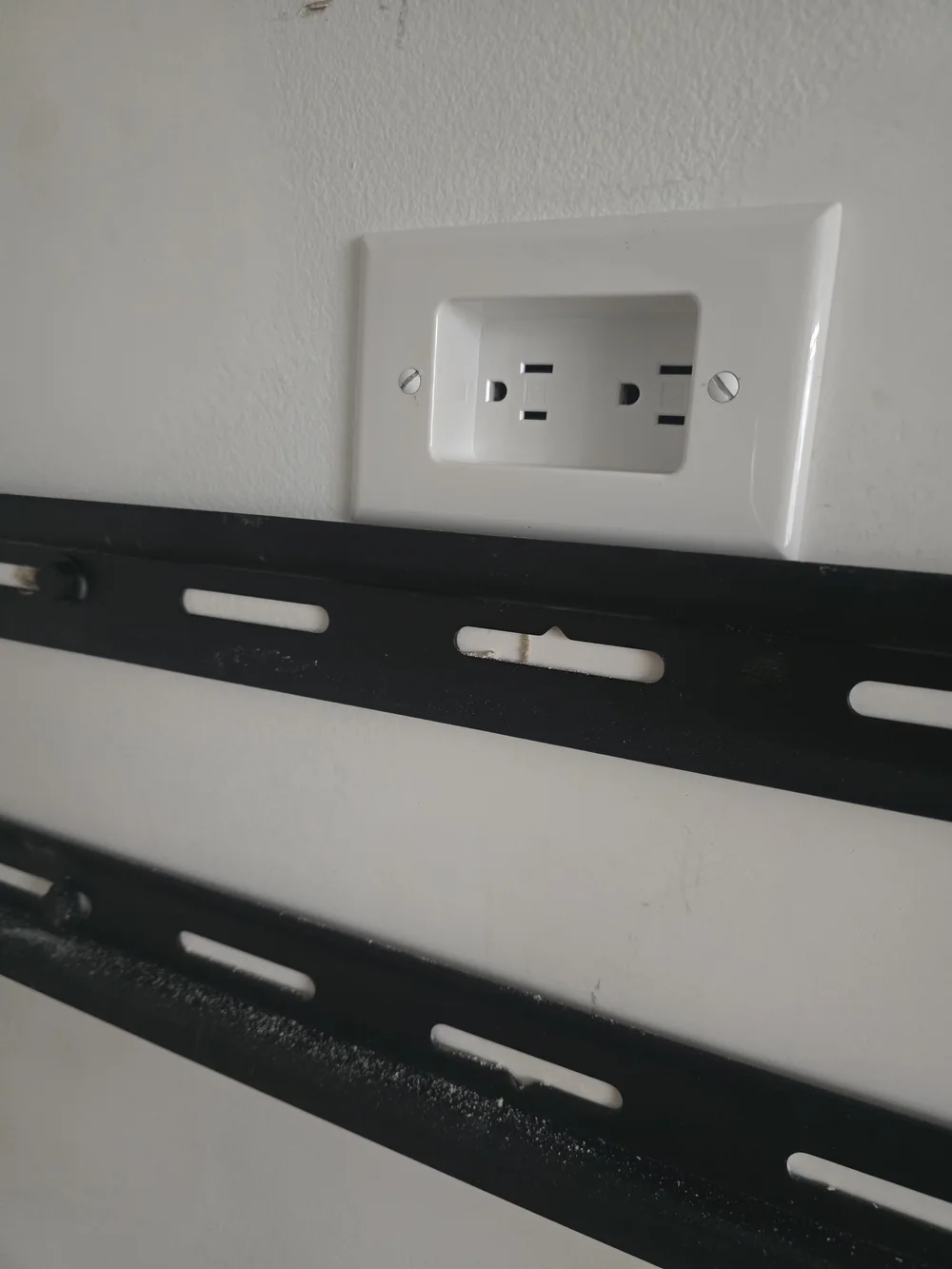 Electrical outlet installed above a TV mount for a wireless smart home experience