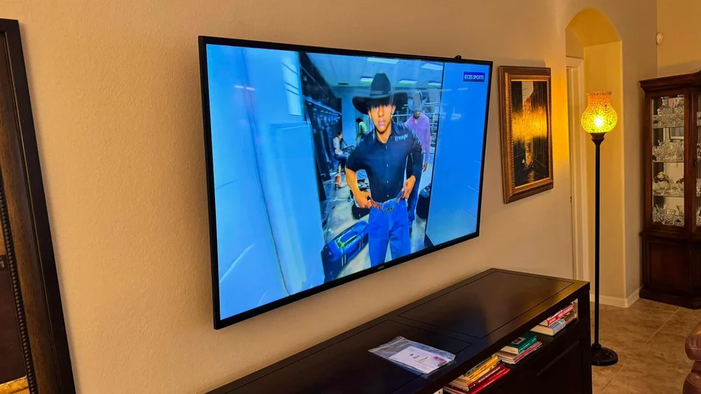 Wireless TV mount with no cables shown above a TV stand in Naples