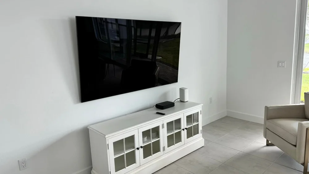 Wireless TV mounting with LG OLED TV and Xfinity modem in Naples