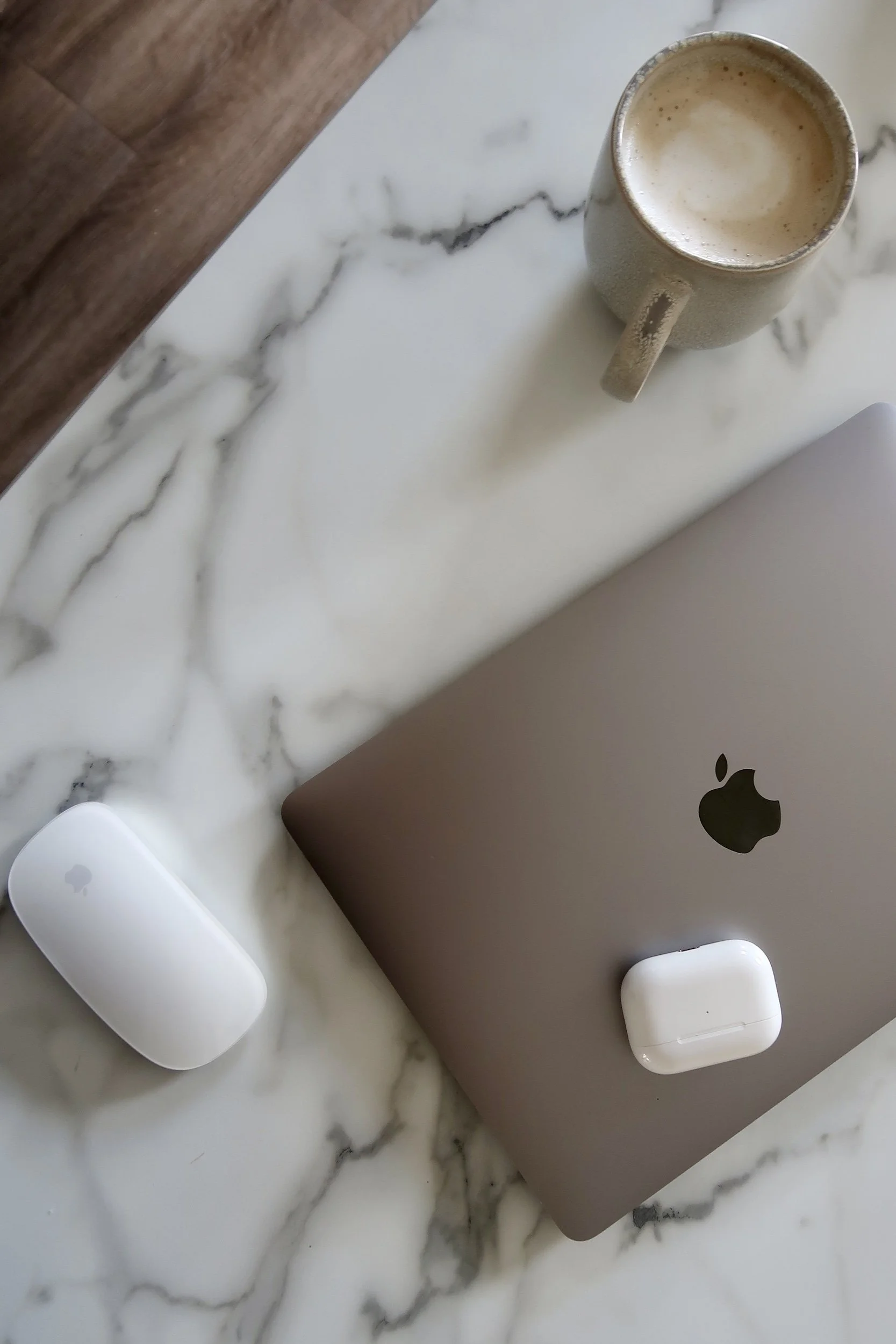Laptop and mouse on marble table