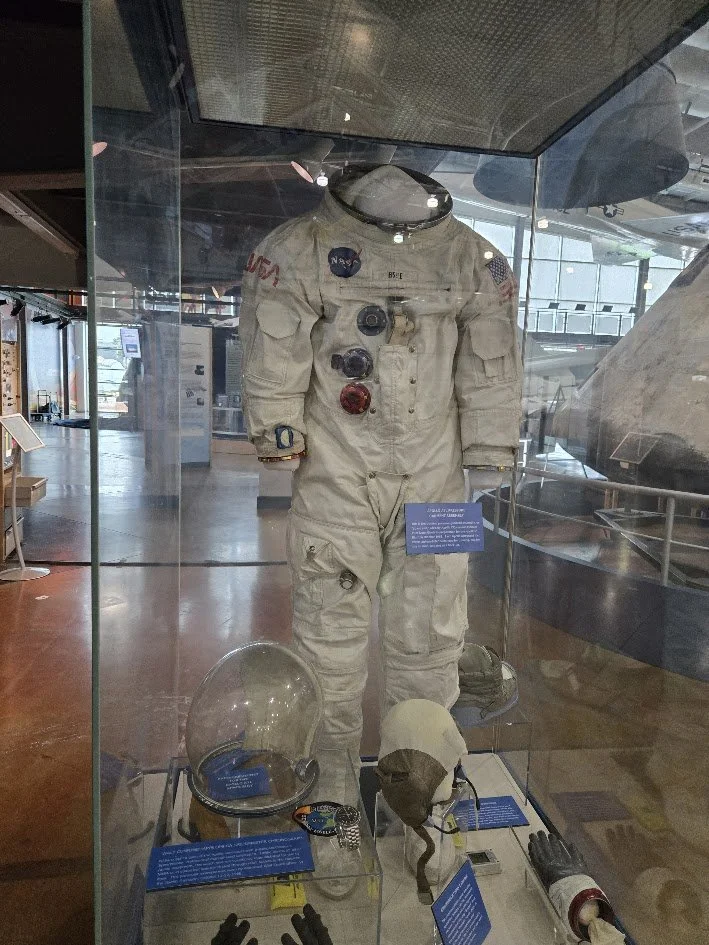 NASA astronaut suit and helmet on display at a museum during a field trip with Beulah's Bunch Camp organizers.