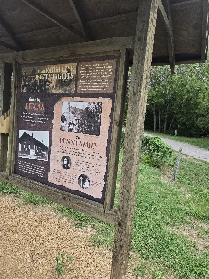 Historical outdoor informational display about the Penn Family, their connection to Texas, and the transition from farmland to city lights during a field trip with Beulah's Bunch Camp organizers..