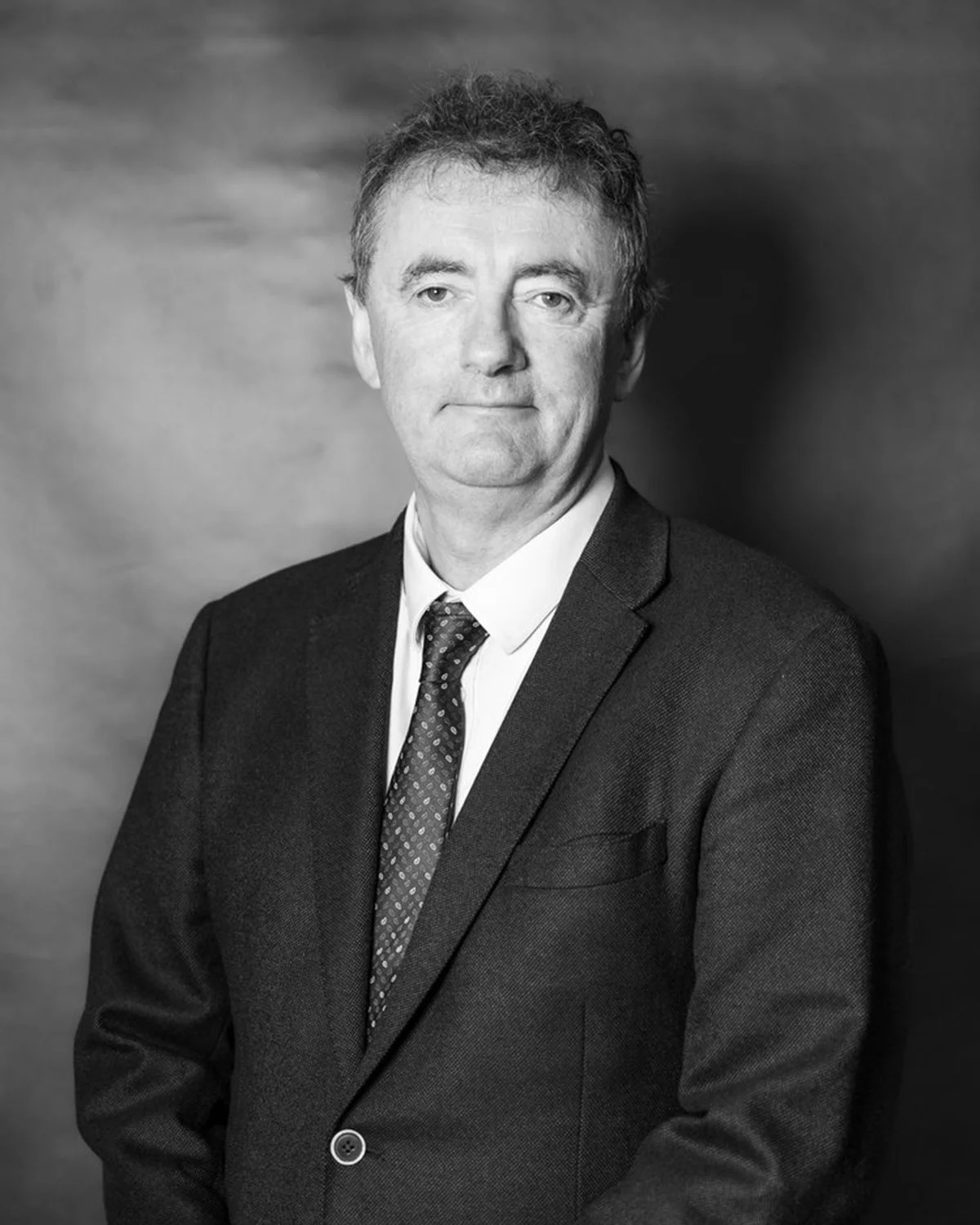 Black and white professional portrait of a Aidan O’Connor Co-founder/Partner of OiLax.