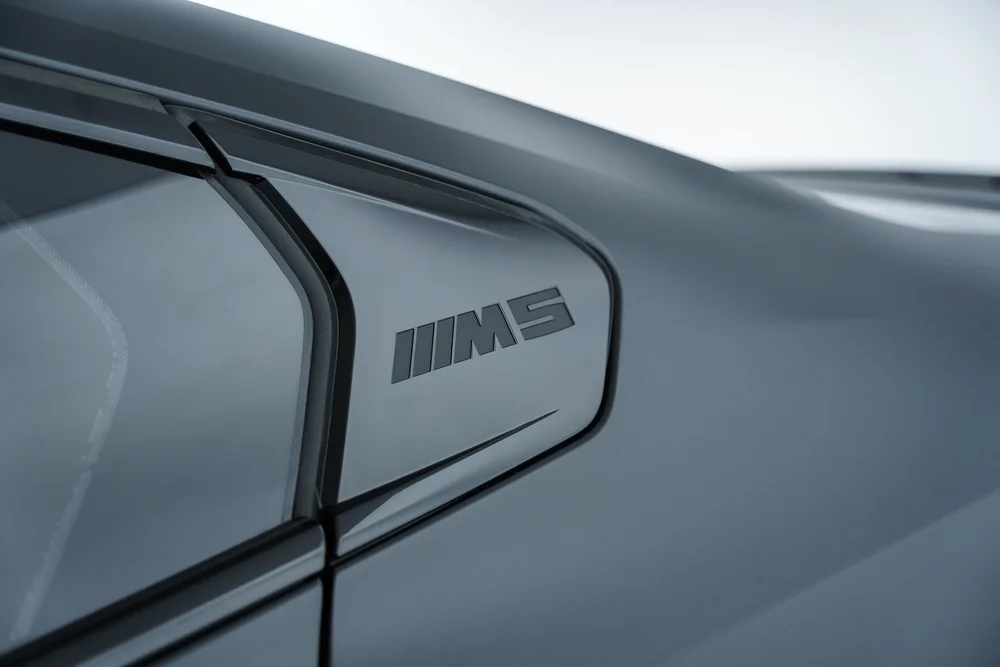 BMW M badge detail near a side window