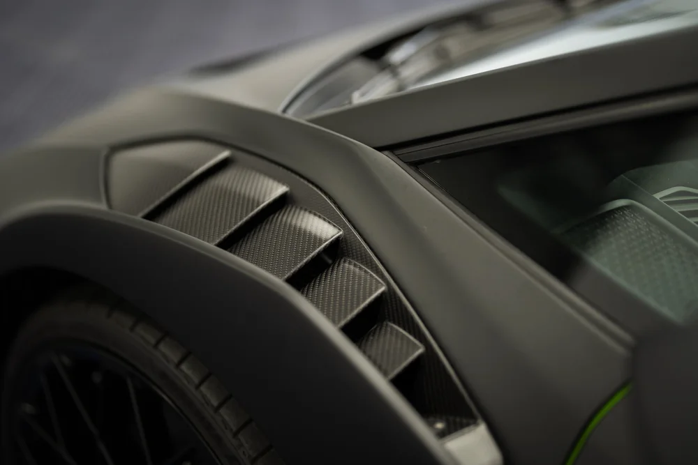 Close-up of a black sports car fender and wheel