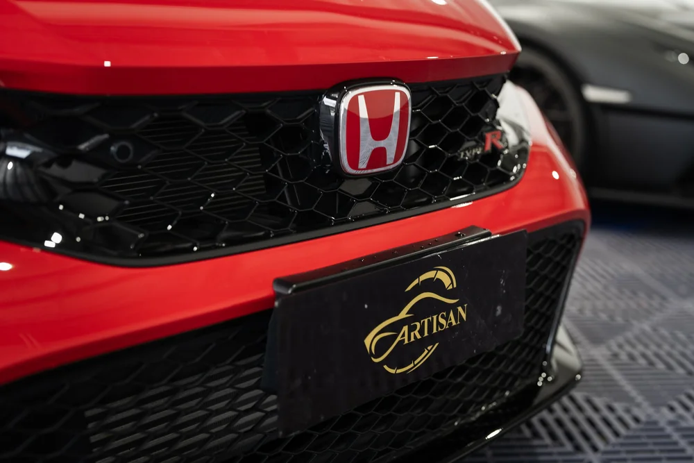 Red Honda front grille with Artisan plate