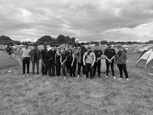 Event team gathered at a festival campsite