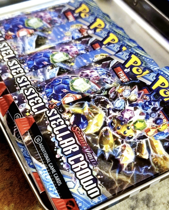 Multiple Pokémon trading card booster packs from the Pokémon Sword and Shield series, featuring a design with Pokémon characters and colorful geometric backgrounds.