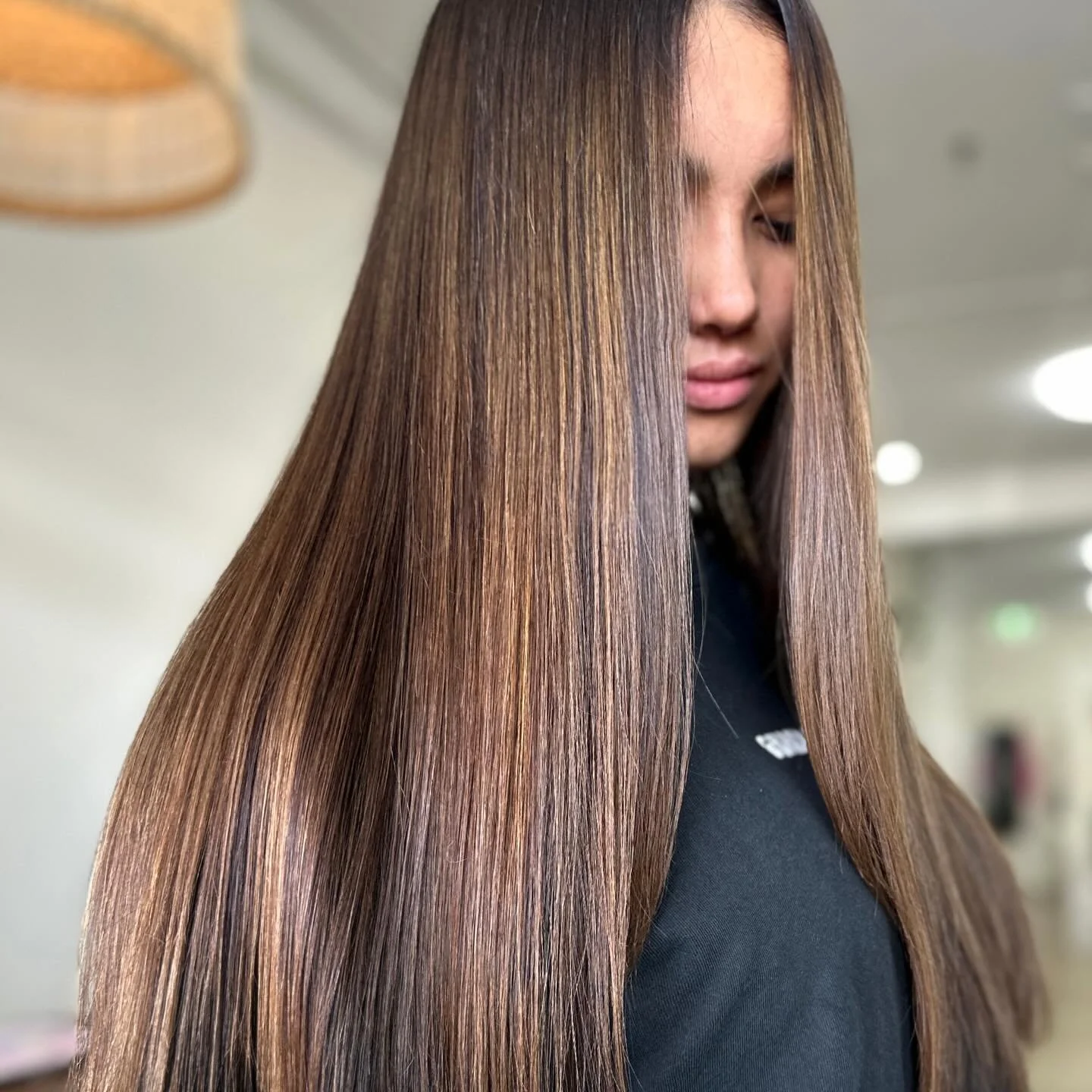 Person with long, straight, shiny brown hair