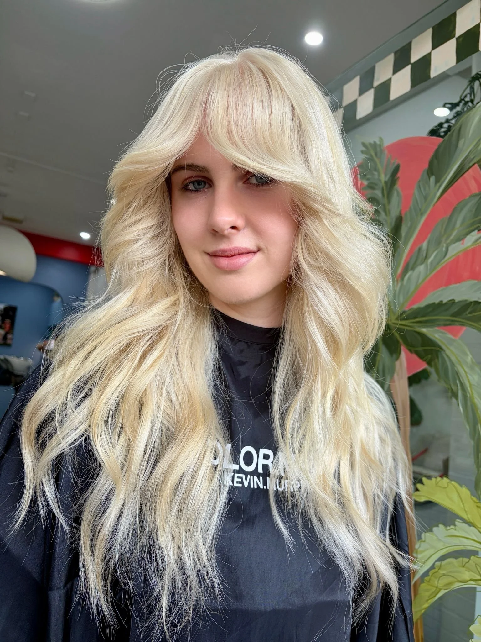 Long blonde hair with loose waves at Bhãva Salon.