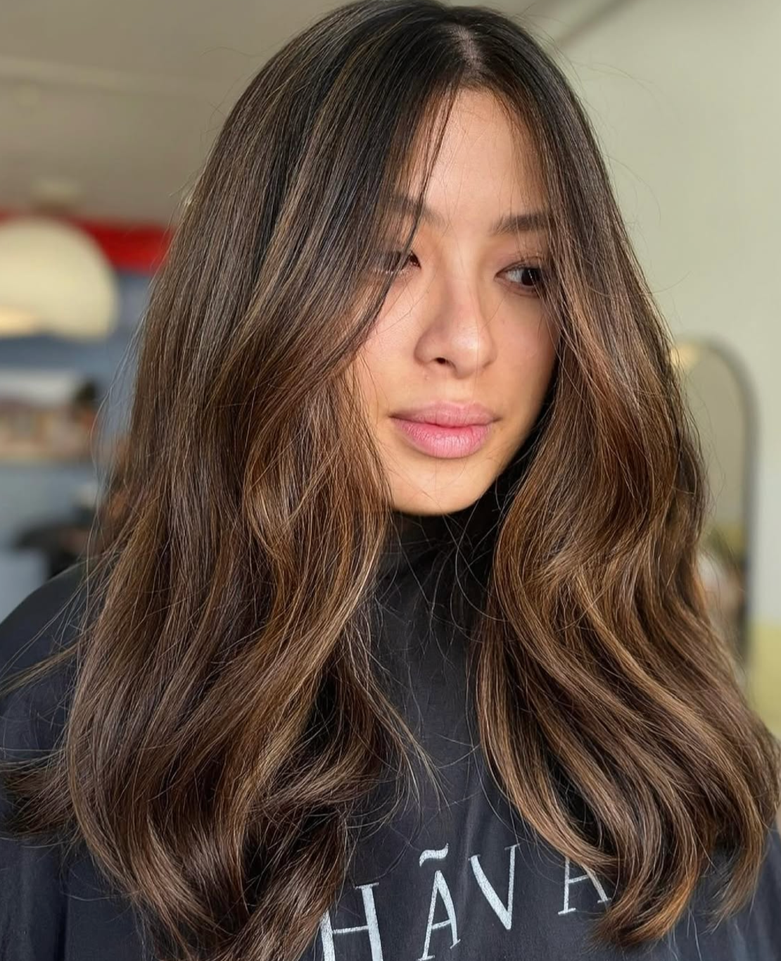 Person with long, wavy, shiny brown hair