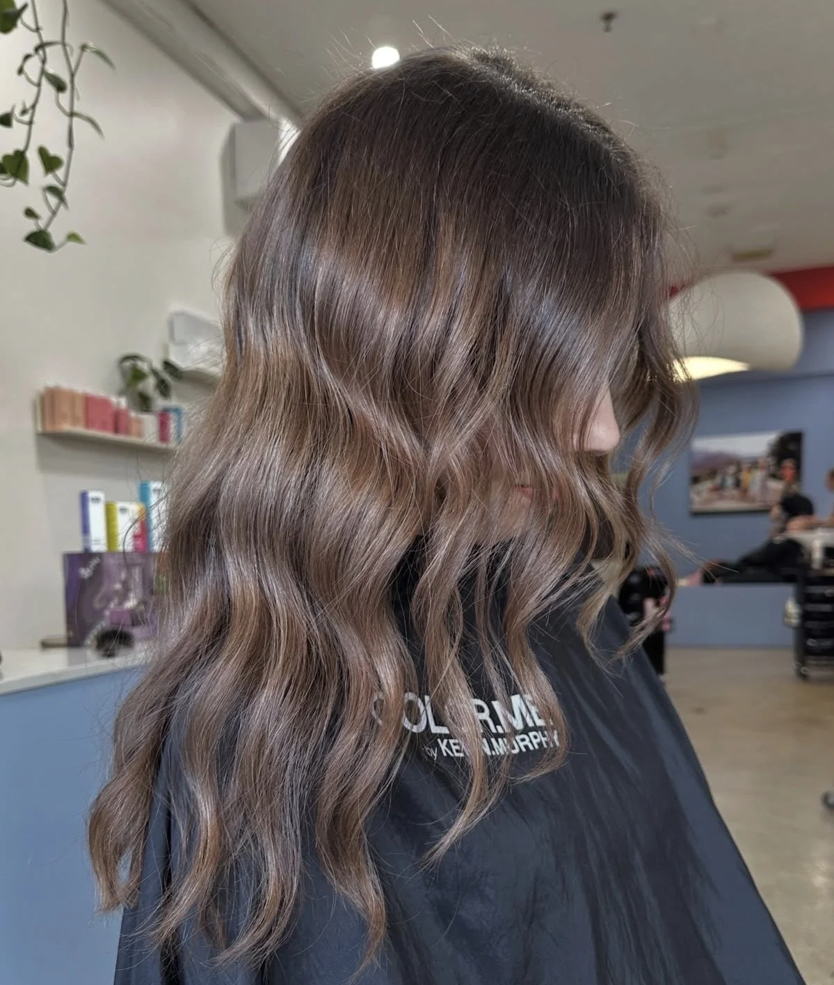 brunette hair colour with long wavy hair coloured by emerging stylist