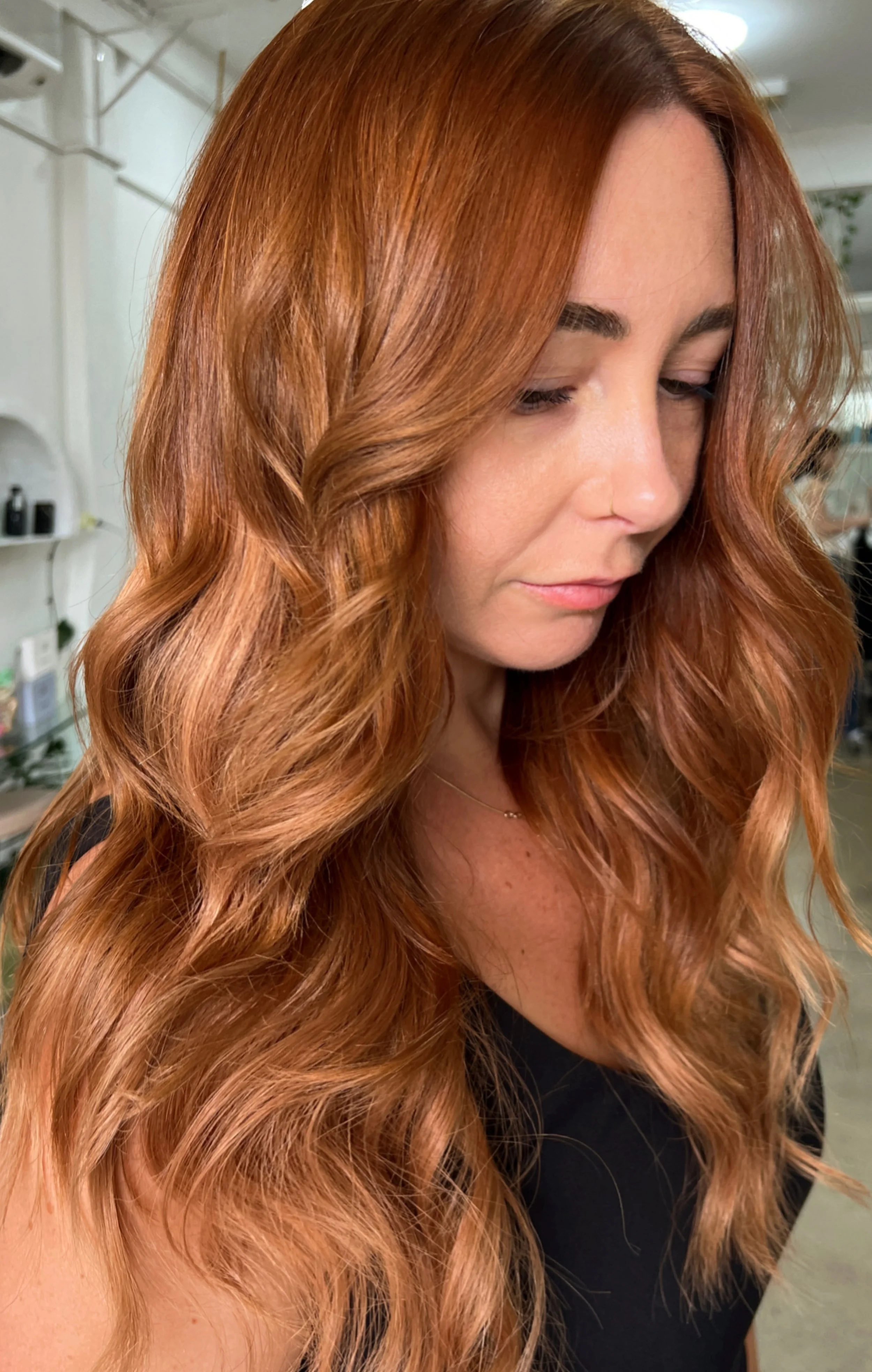 Soft waves and warm brown colour with lighter pieces around the face at Bhãva Salon