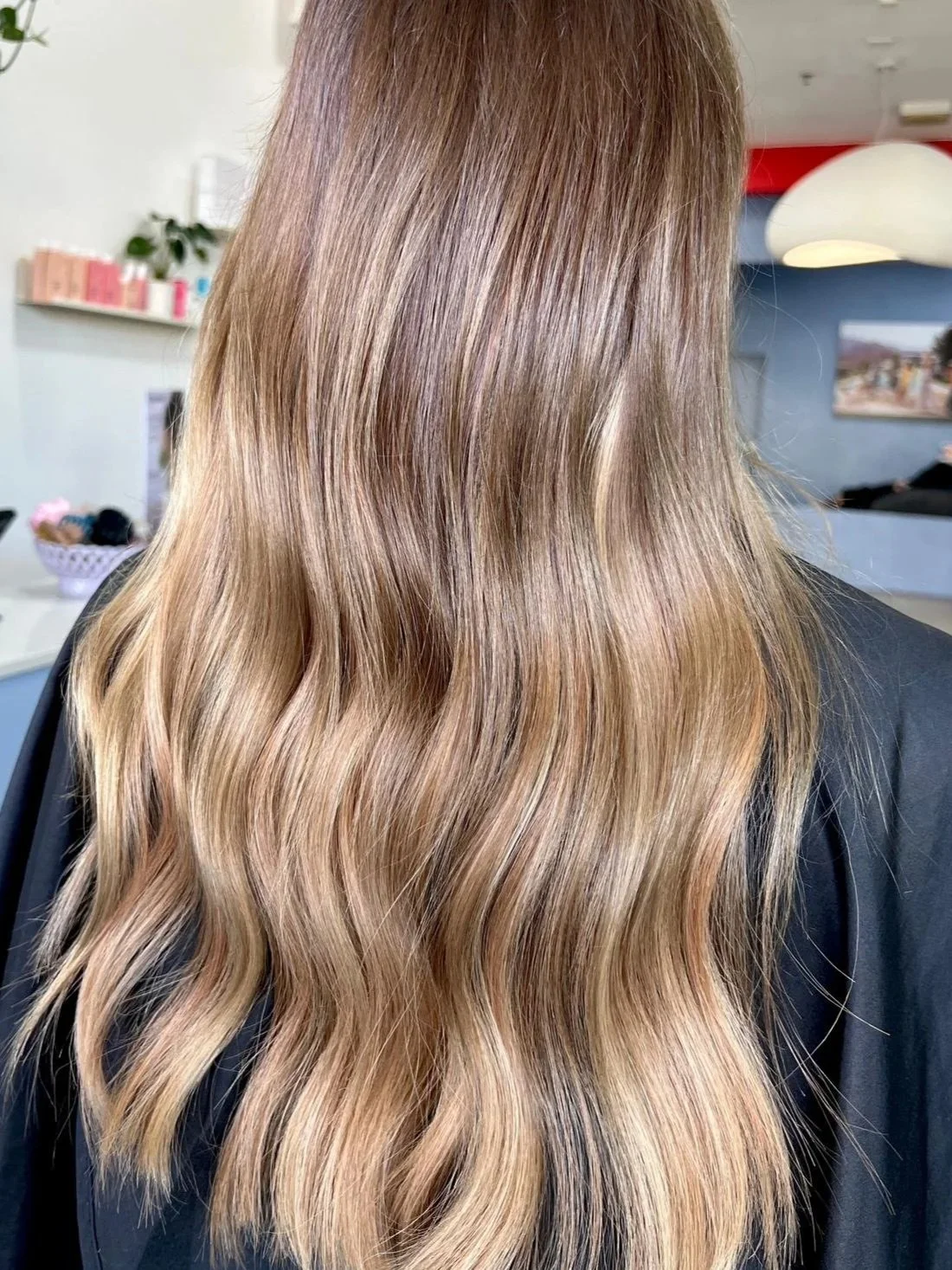 Wavy long extensions in hair with a copper and brunette colour