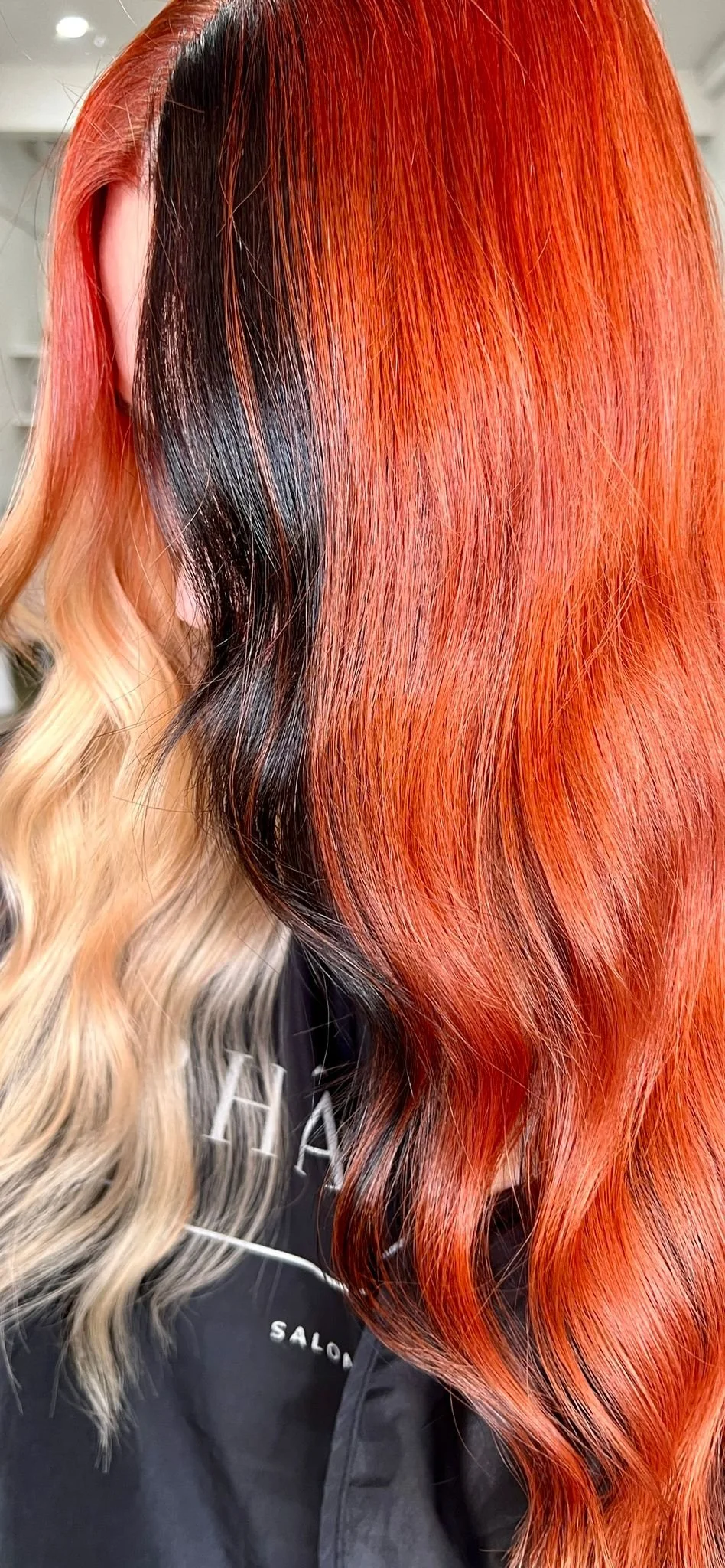 Wavy red and blonde hair in a salon setting.