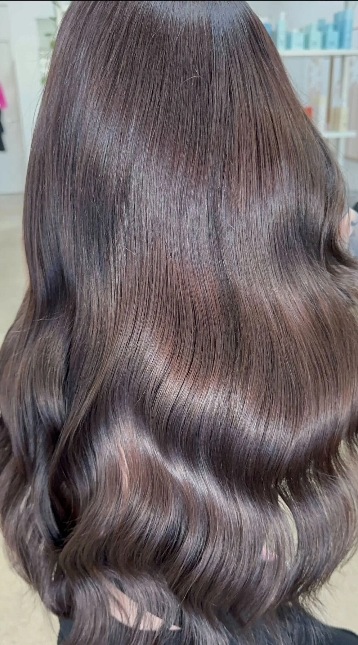 Close-up of wavy brunette hair with softly blended lighter ribbons at Bhãva Salon in Teneriffe