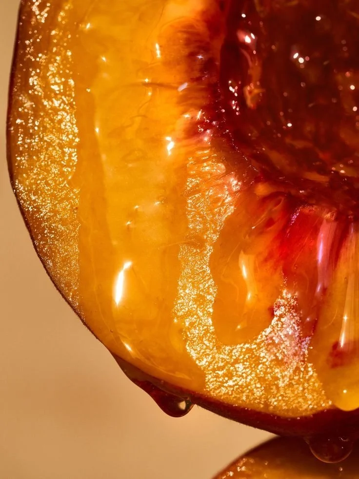 Close-up of a peach slice showing its juicy, yellow-orange flesh and textured surface.