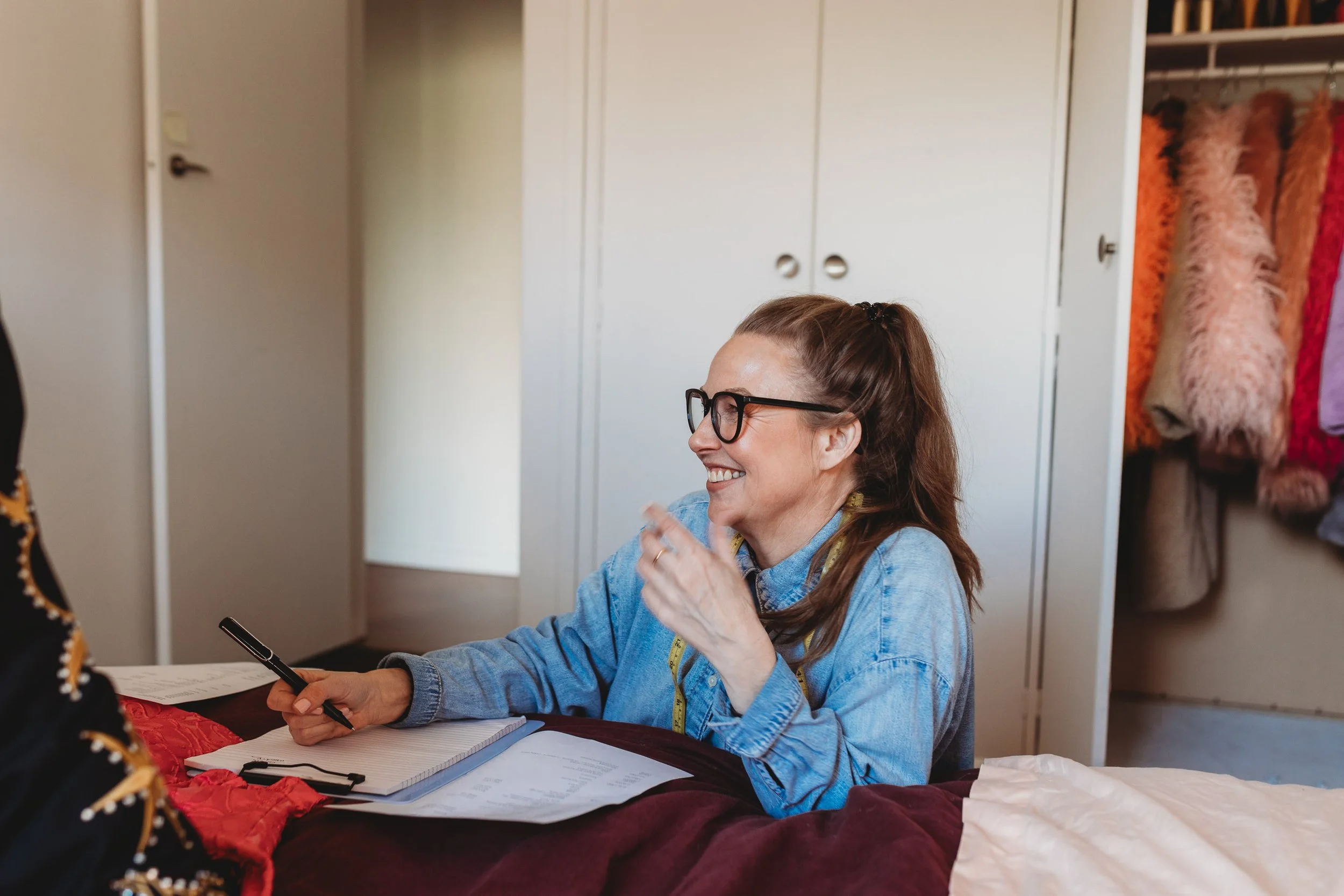 Anna Svedberg, personal stylist and social scientist, laughing during an in-home wardrobe session with a client in Toorak, Melbourne
