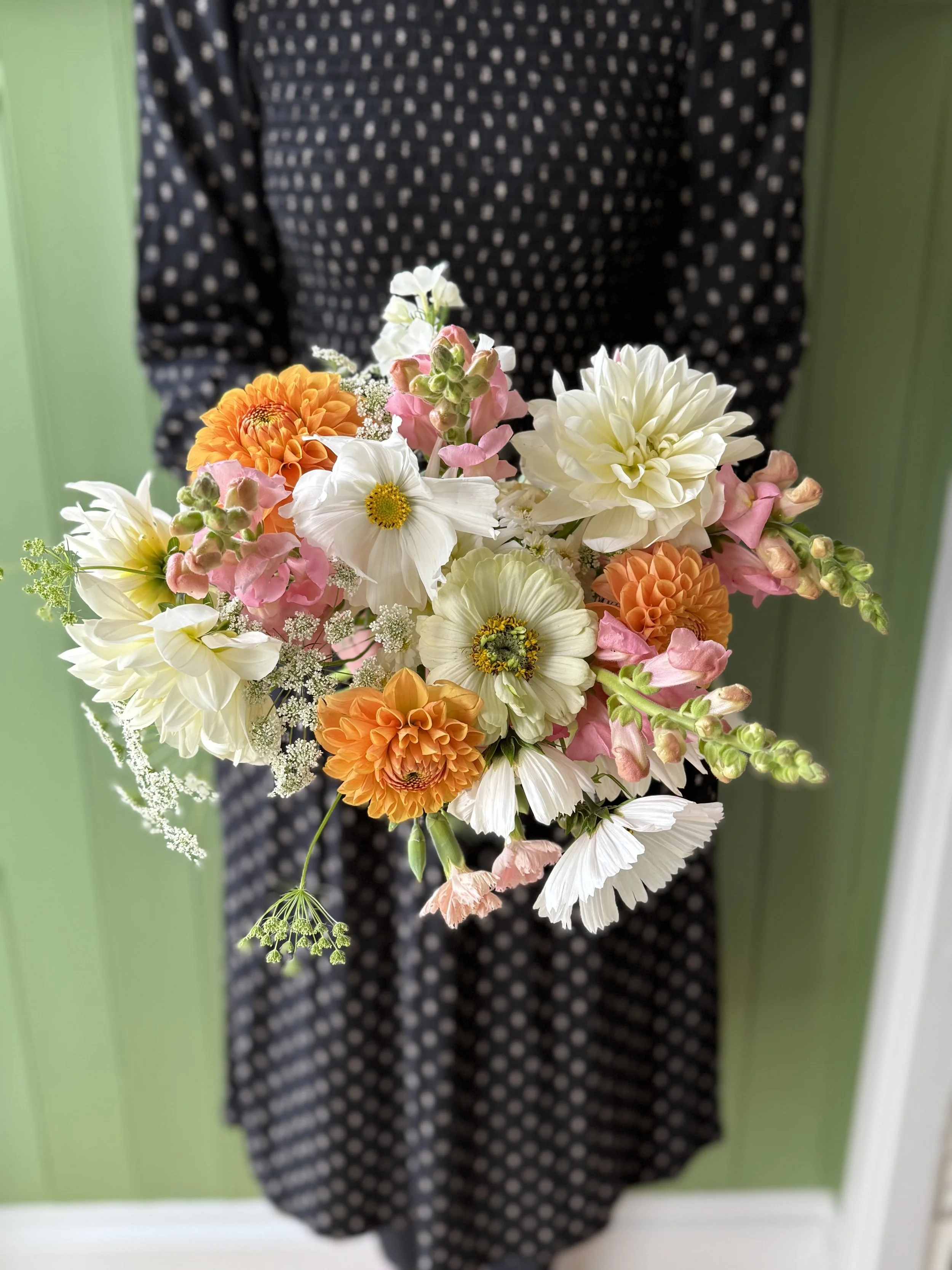A summer bouquet using british flowers, featuring cosmos, dahlias, snapdragons