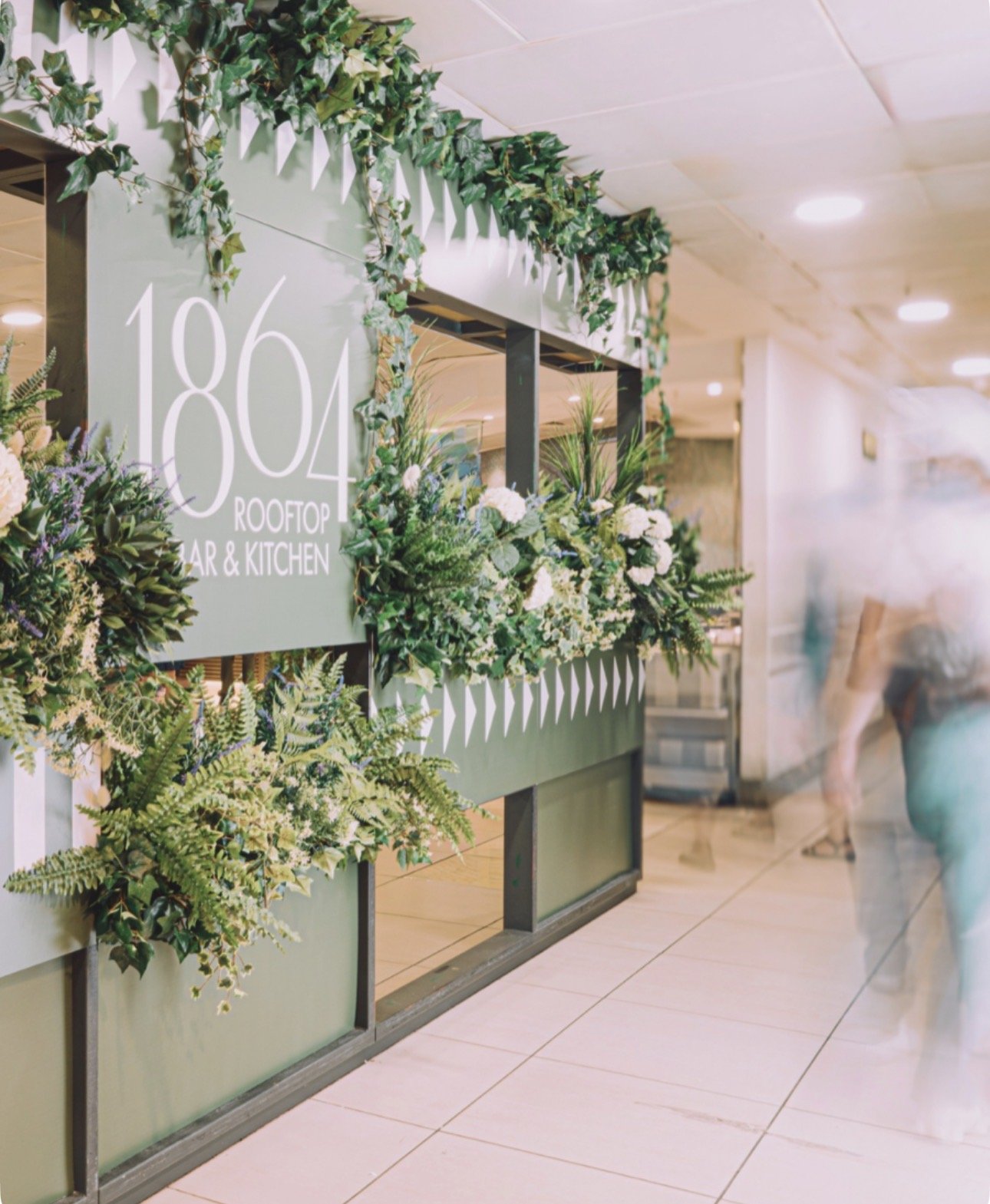 Interior planting scheme with layered artificial foliage for commercial space