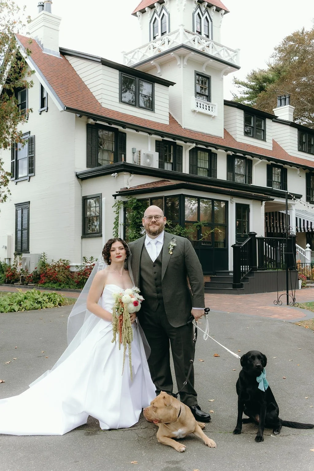 Photo of the couple and their dogs at their Estate Wedding in fall.