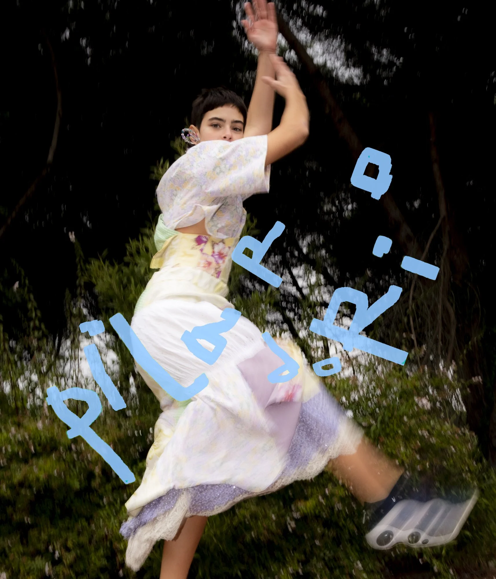 A young girl in a floral dress is swinging on a tree branch outdoors, with a dark leafy background and the word 'Pliés' written in blue across the image.