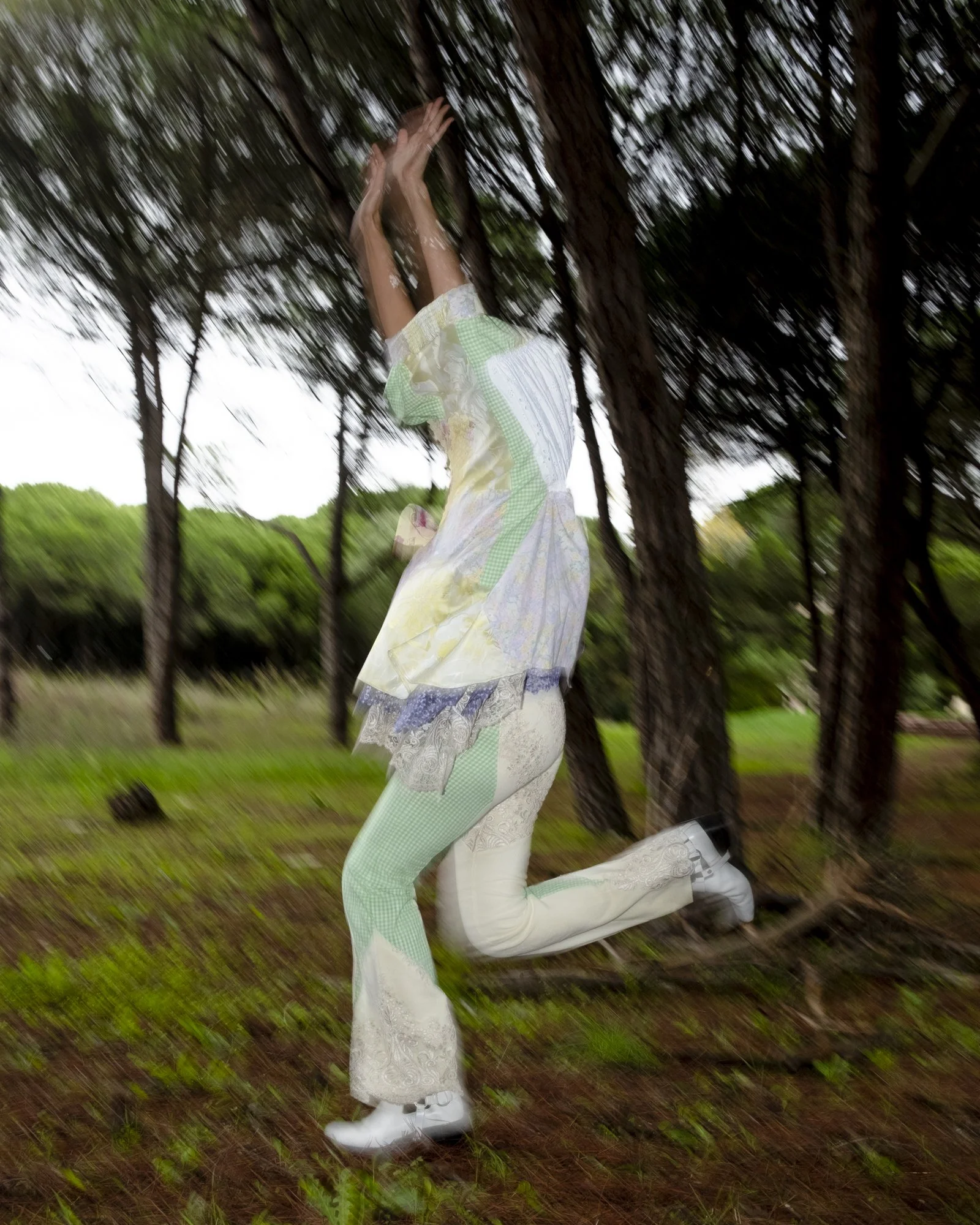 Person running outdoors in a forested area, captured in motion with a blurred background.
