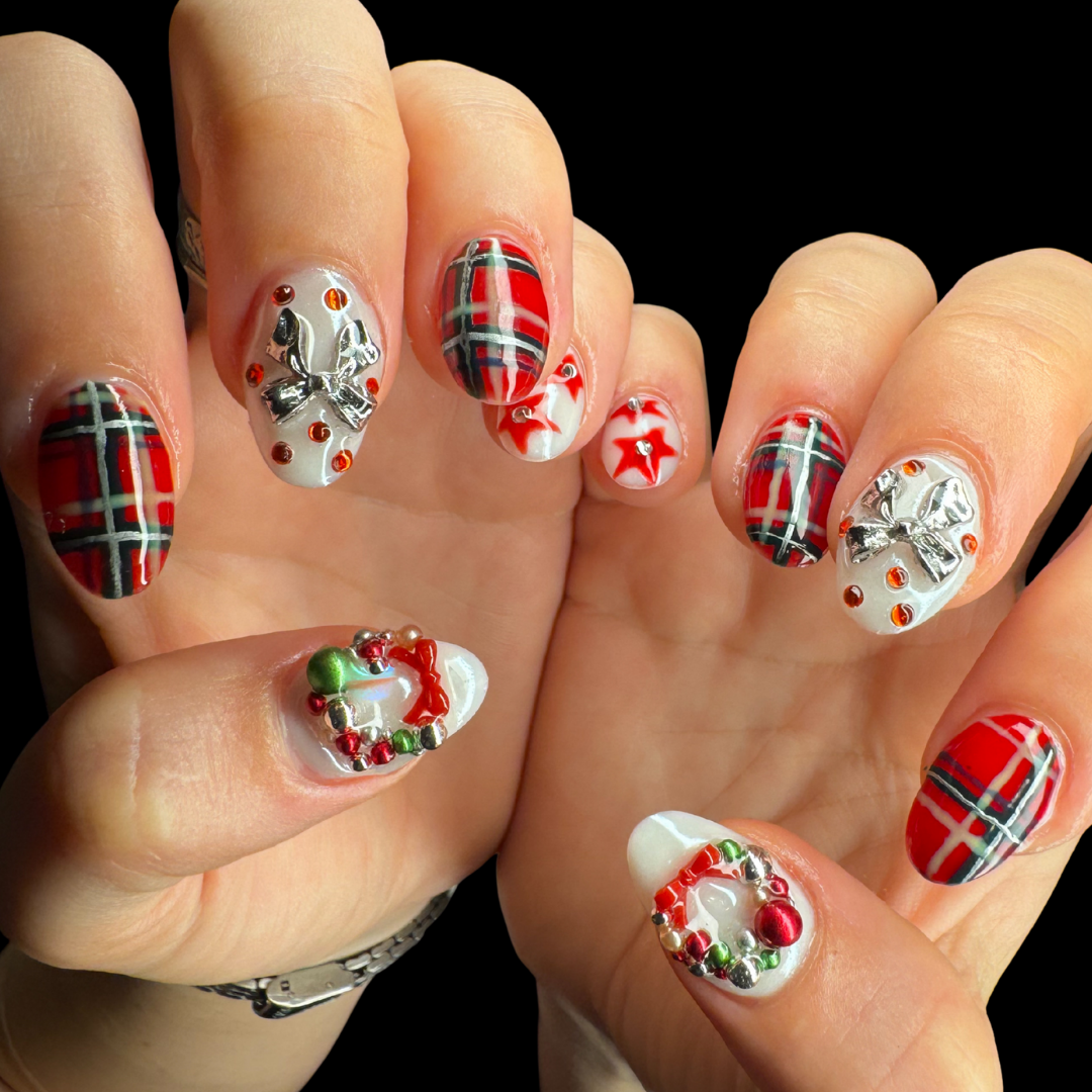 gel nails hand painted with tartan bow stars gems and charms red seasonal theme