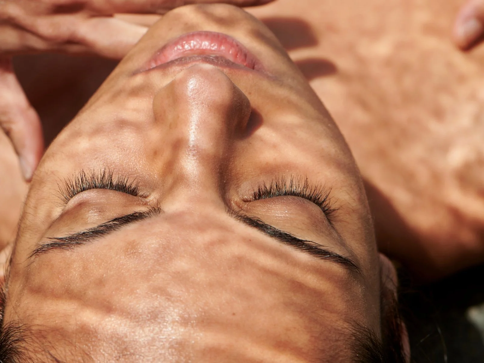 rejuvenation ipl targets water in the skin - image shows woman with droplets reflecting through light over natural face