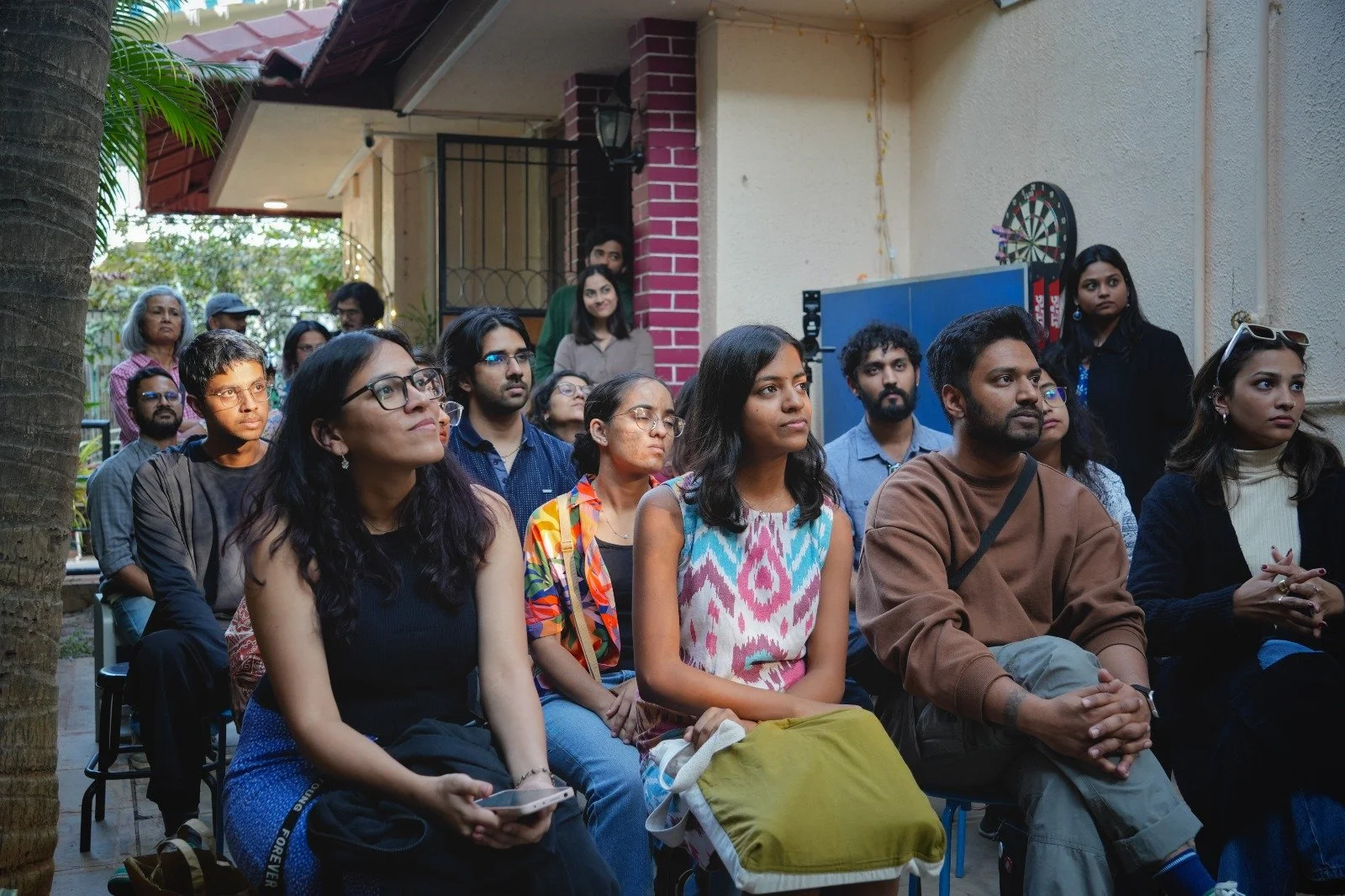 A group of creatives listening to the JAM speaker
