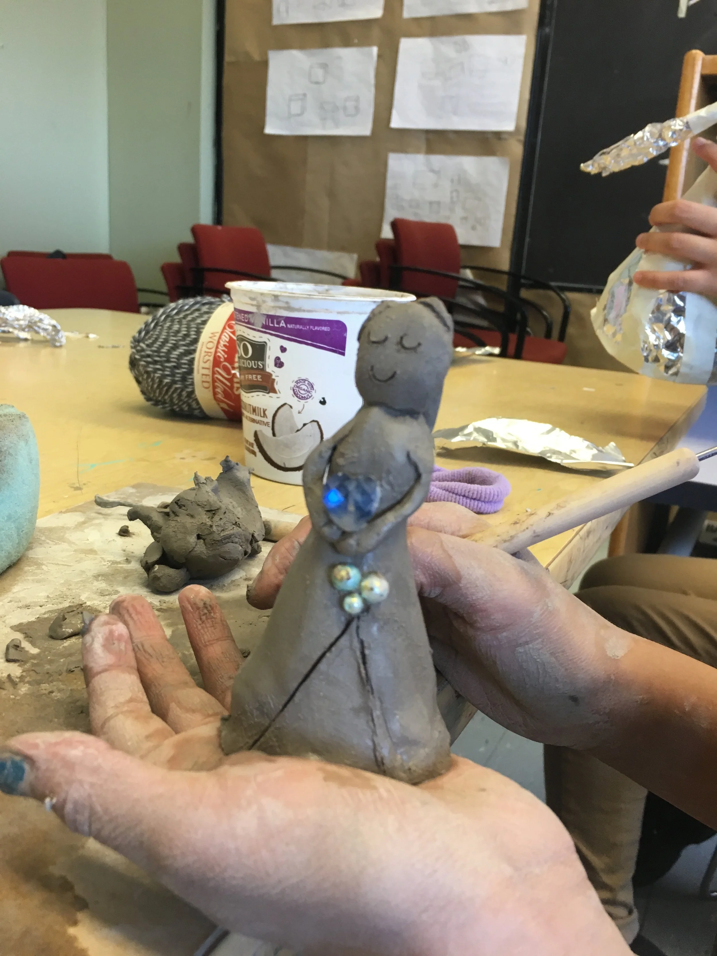 a figure in clay with ornaments