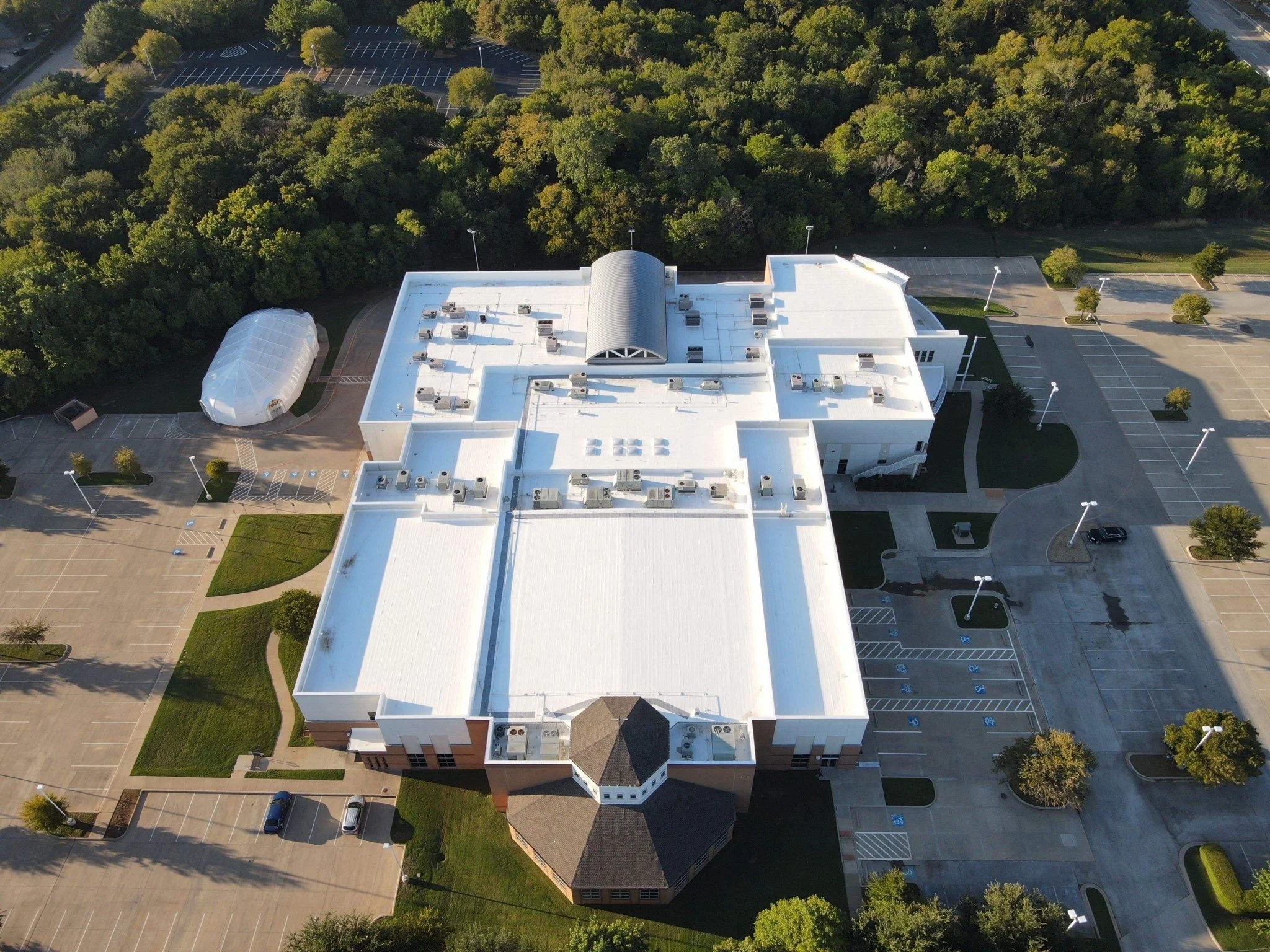  Large commercial or industrial building with a flat roof, silicone roof coating