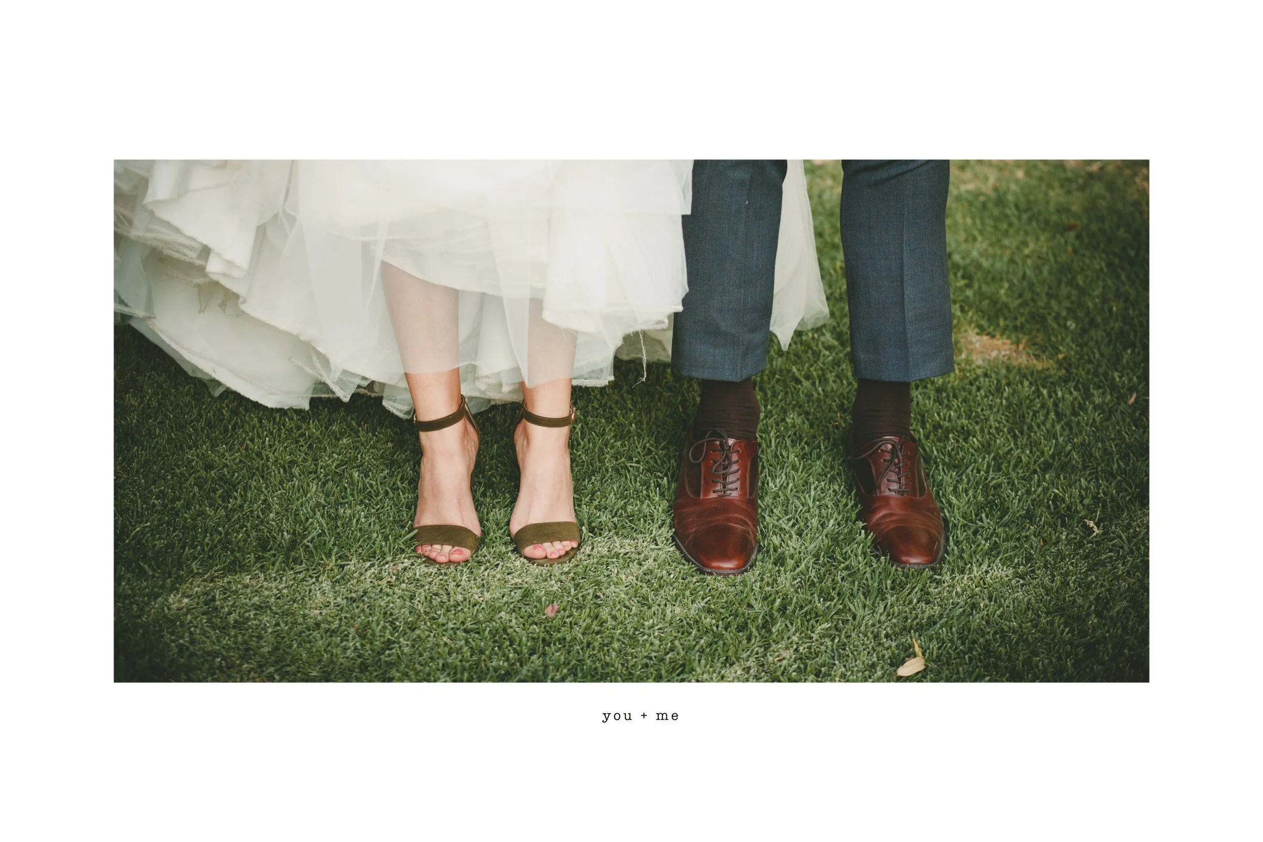 Bride and groom's feet on grass, bride in white dress and sandals, groom in suit and brown shoes, with text "you + me" below.