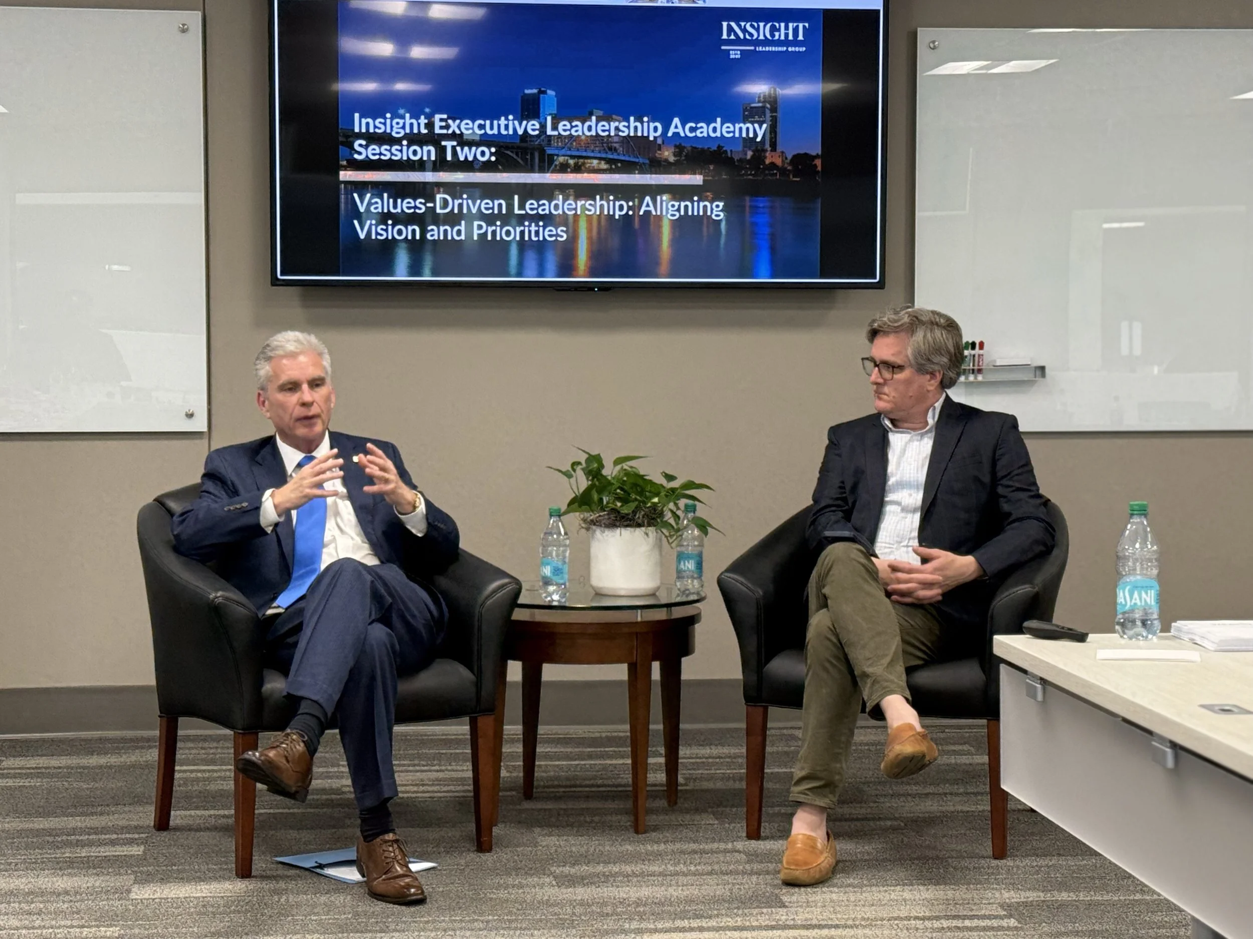 Chris Bahn, Founder and Principal of C. Bahn Strategic Partners, moderating an on-stage conversation with business leaders in Arkansas.