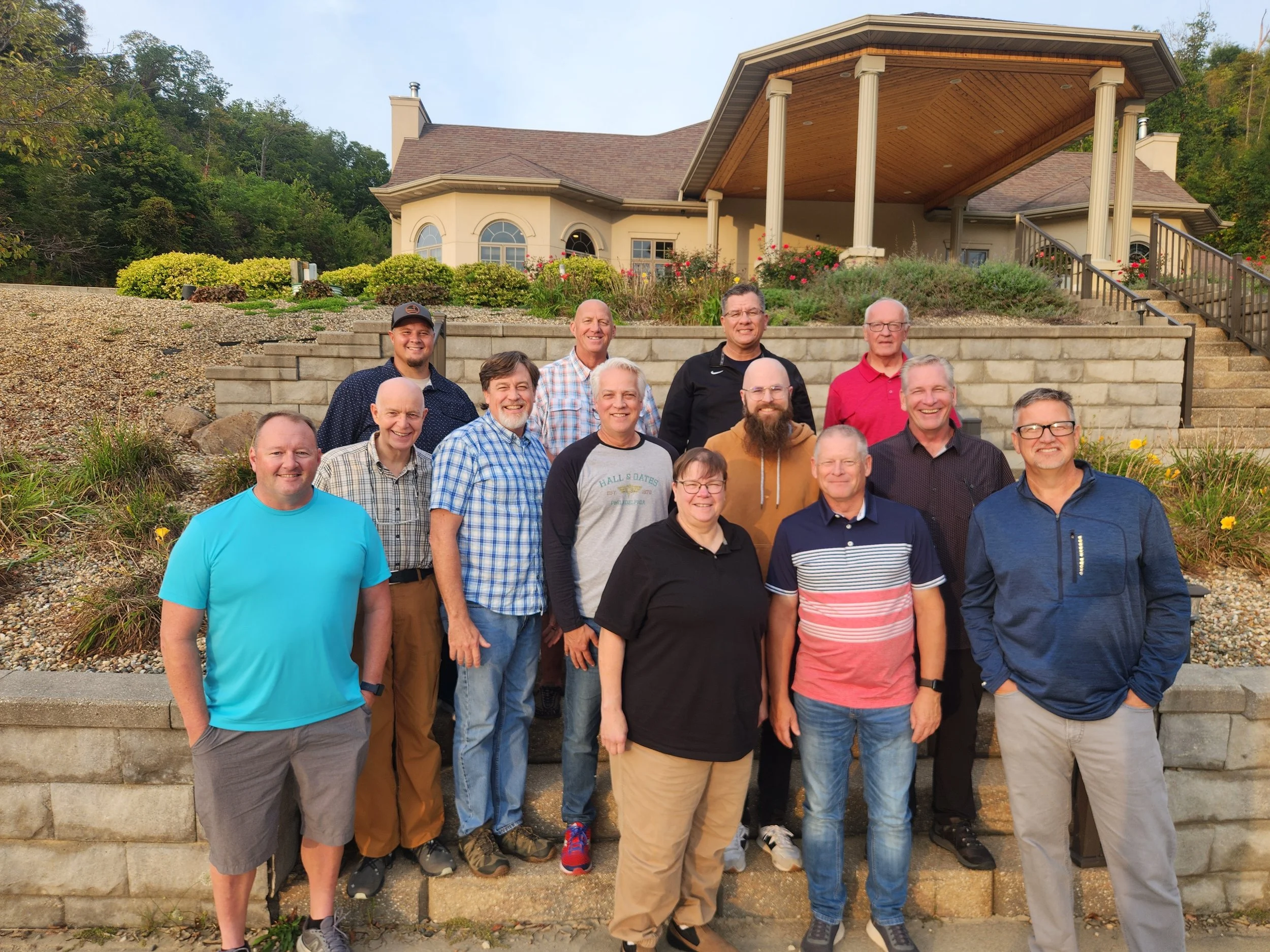 People standing in a line holding hands.